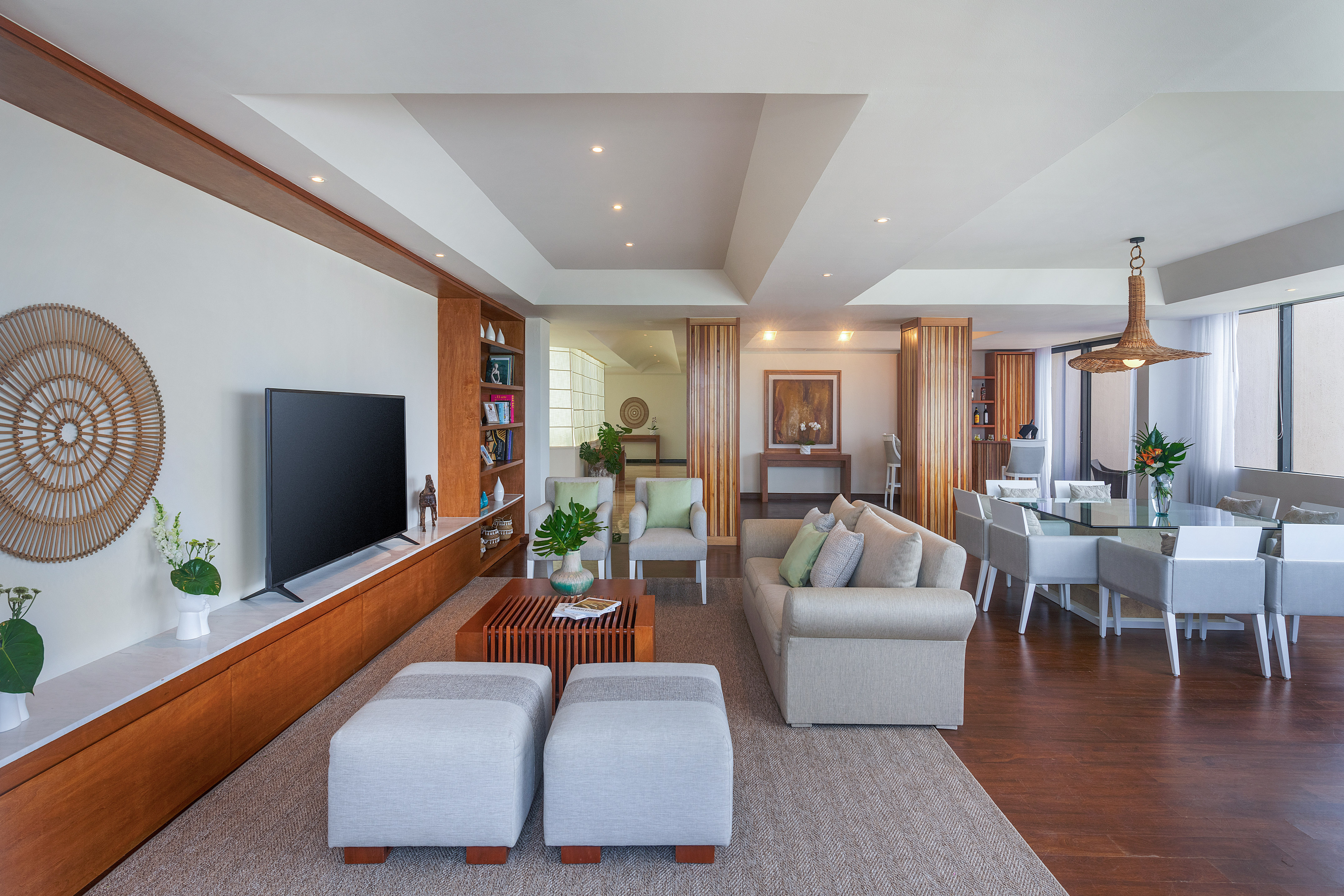 Modern neutral living and dining room, wood accents.