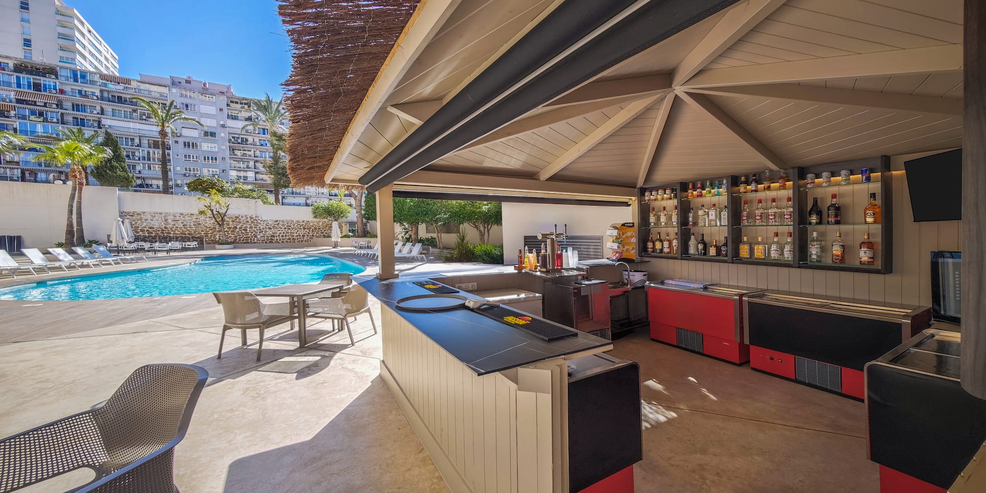 a pool with a bar and chairs