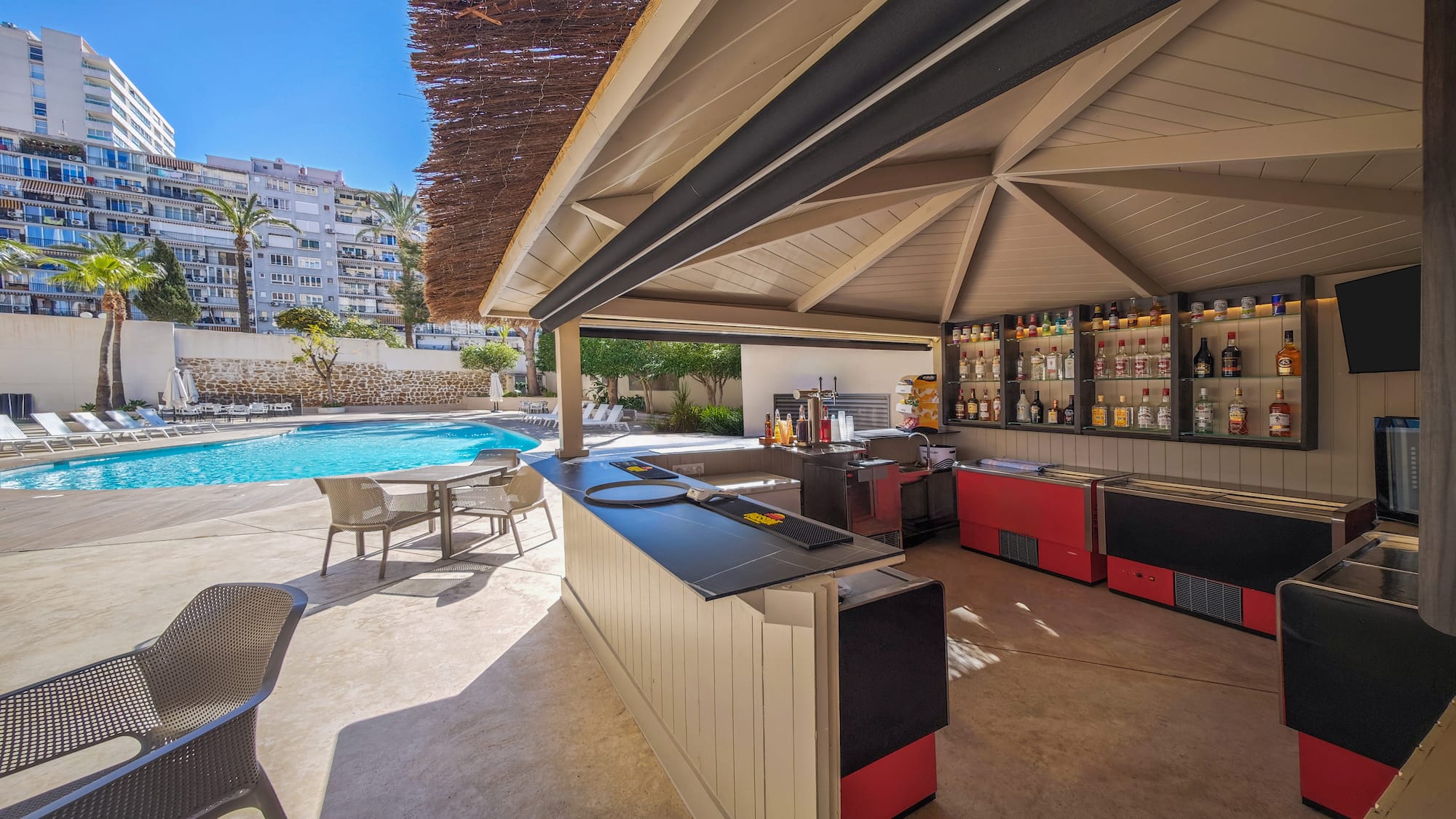 a pool with a bar and chairs