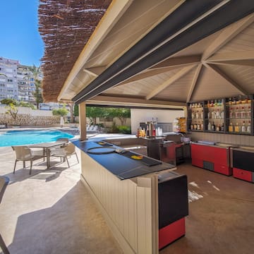 a pool with a bar and chairs