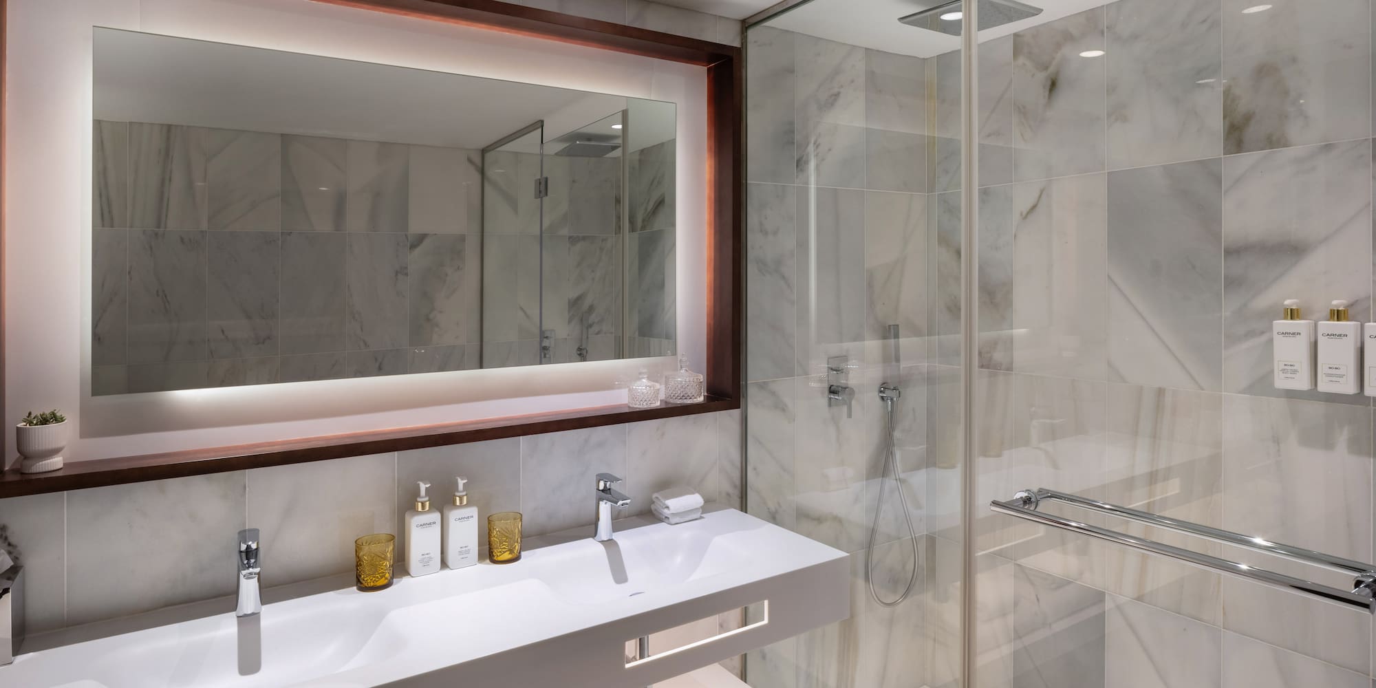 a bathroom with a mirror and a shower