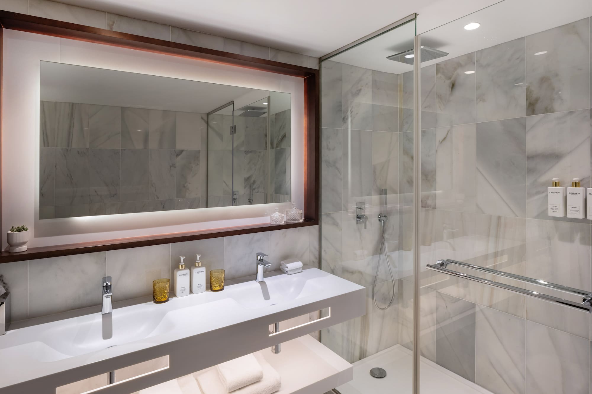 a bathroom with a mirror and a shower