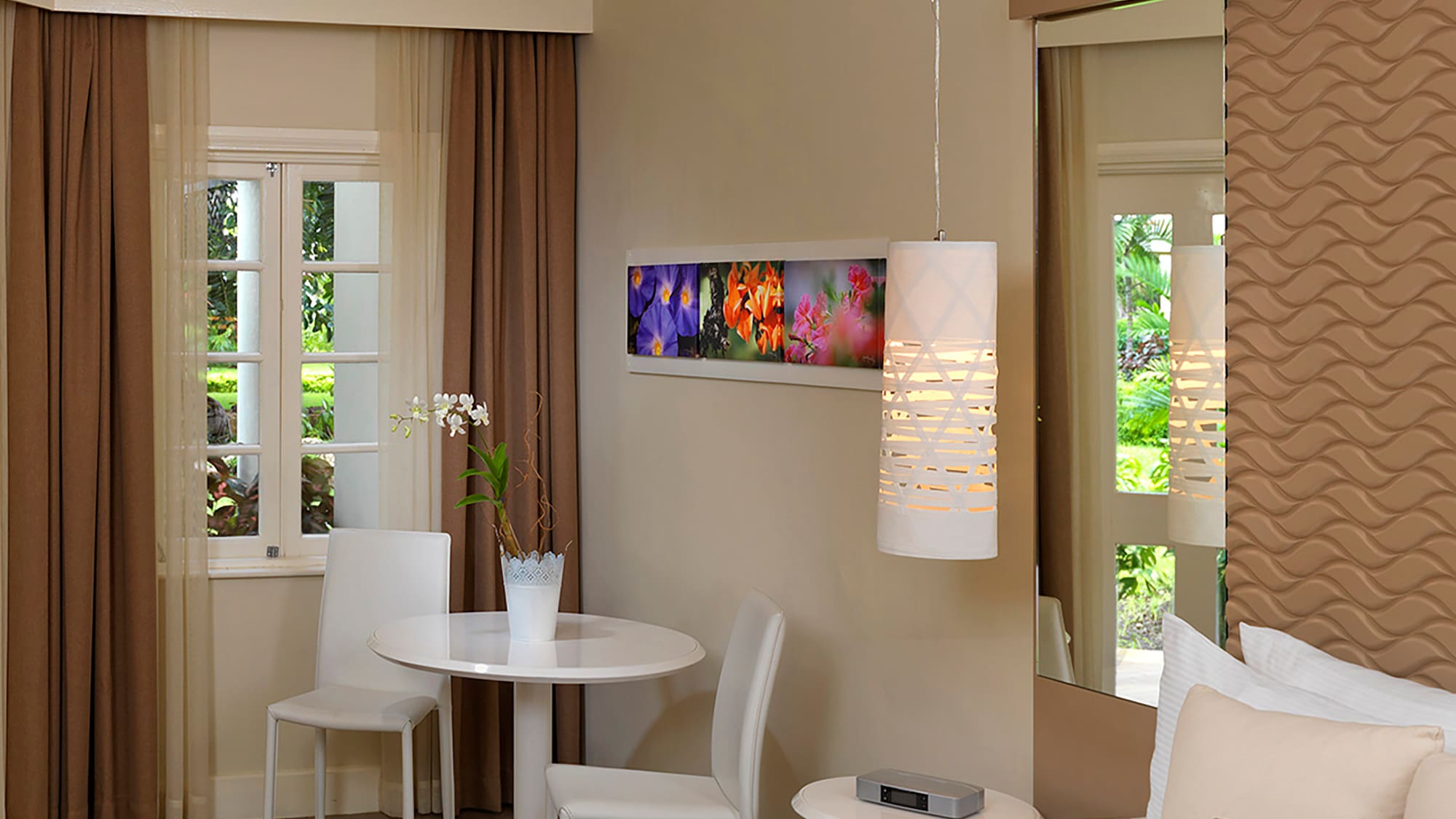 a room with a bed and chairs