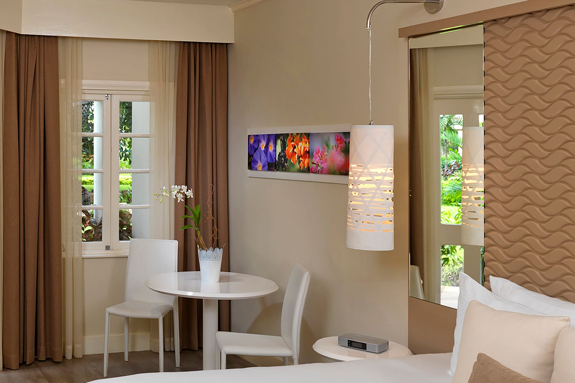 a room with a bed and chairs