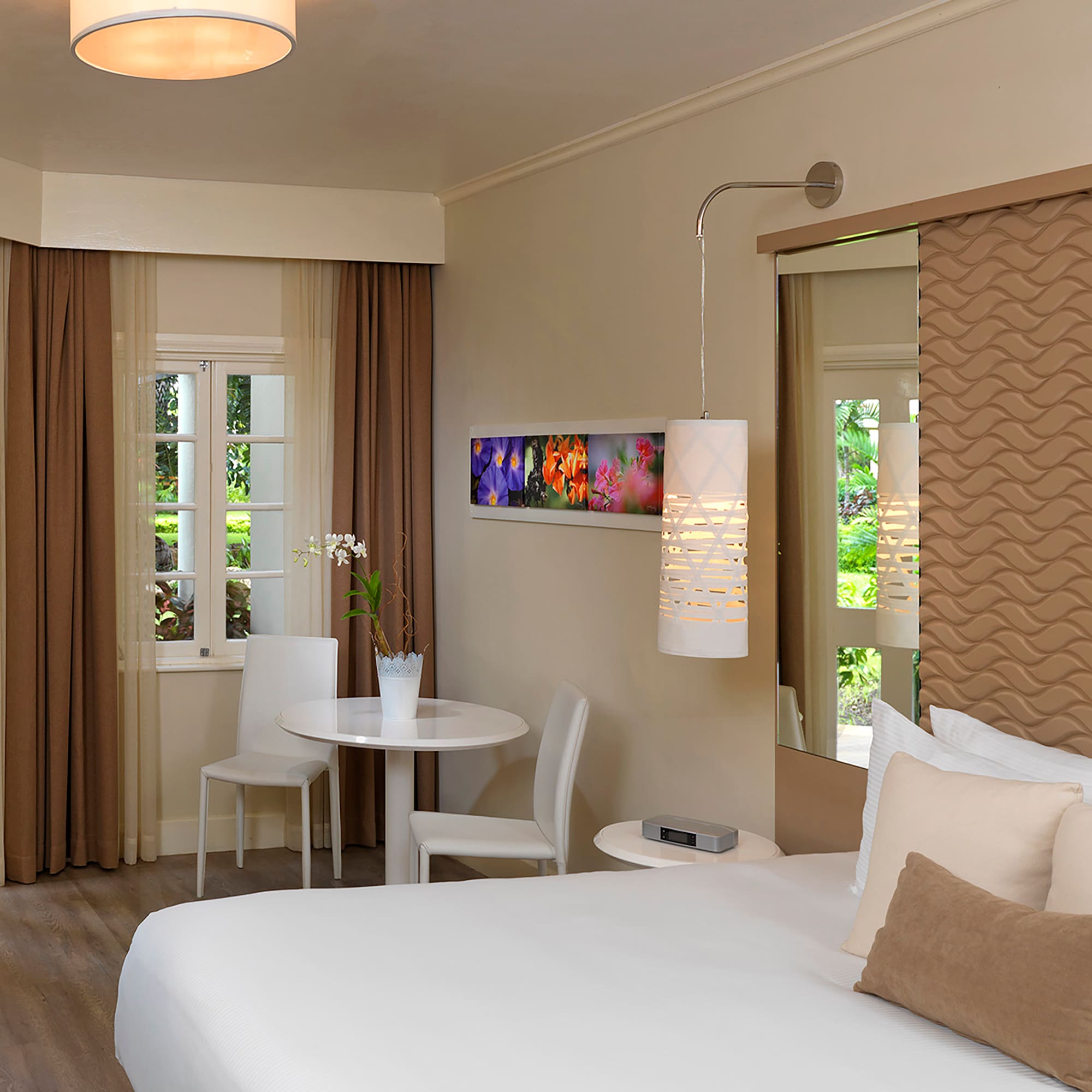 a room with a bed and chairs