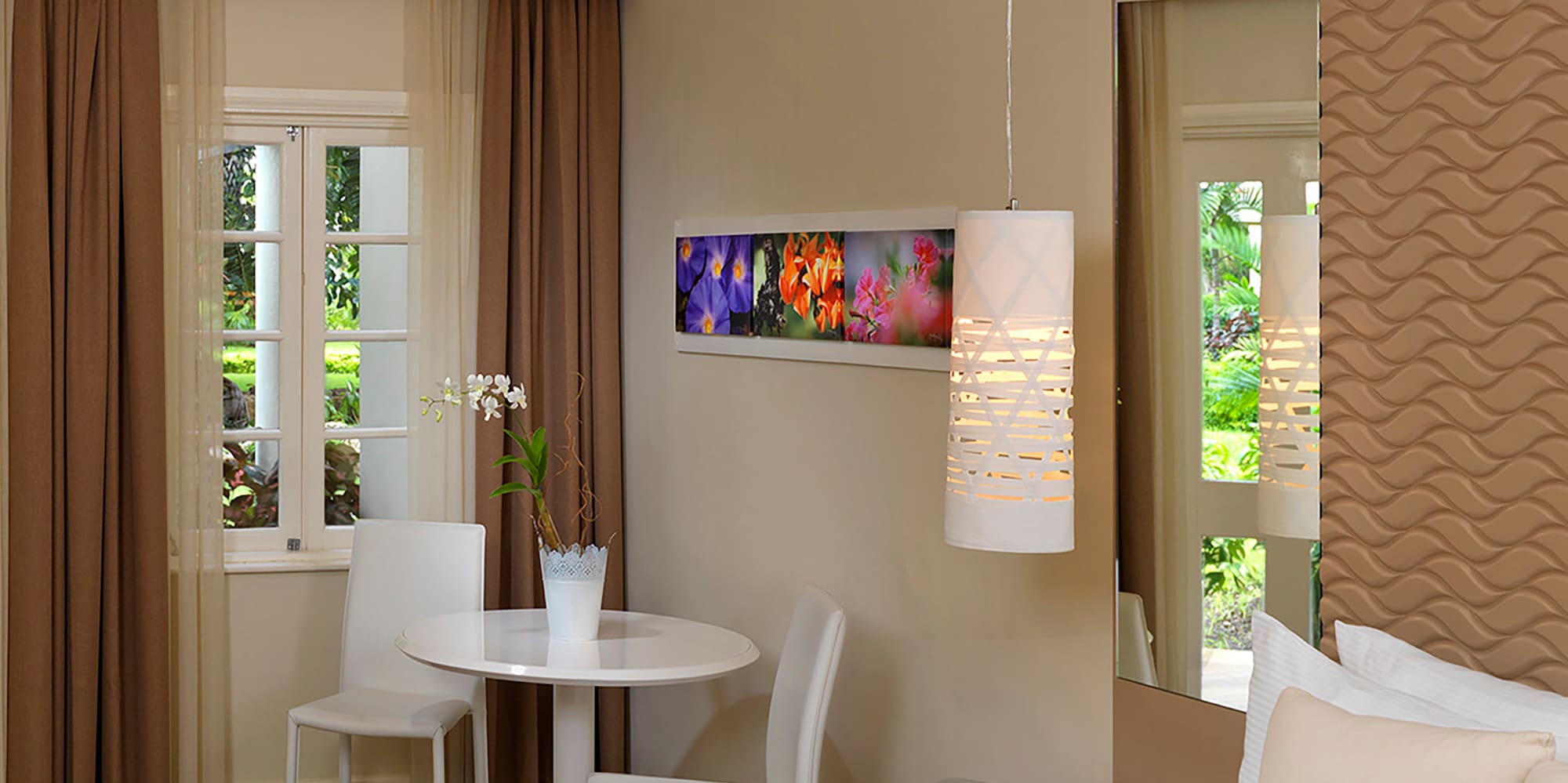 a room with a bed and chairs