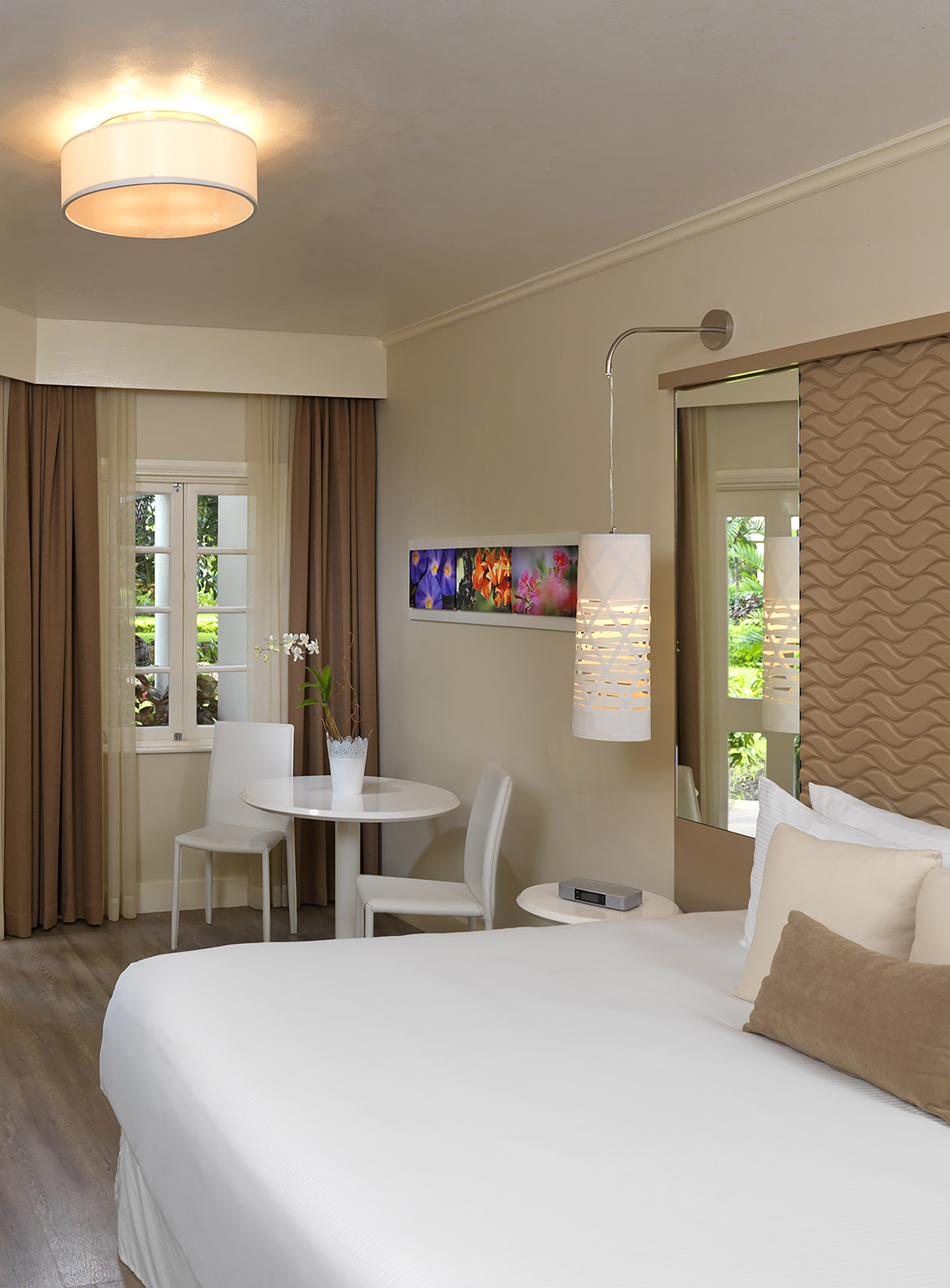 a room with a bed and chairs