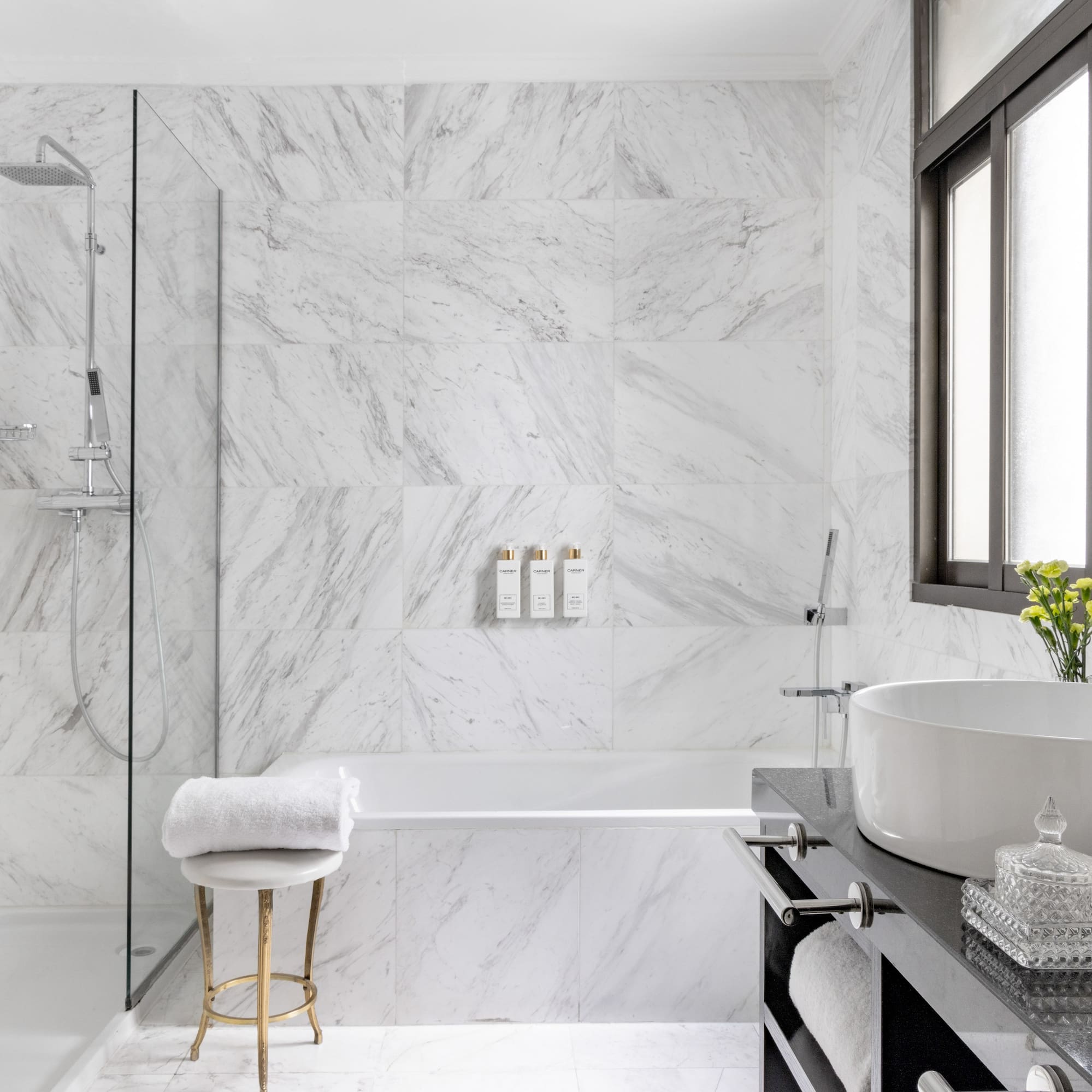 a bathroom with marble walls and a sink