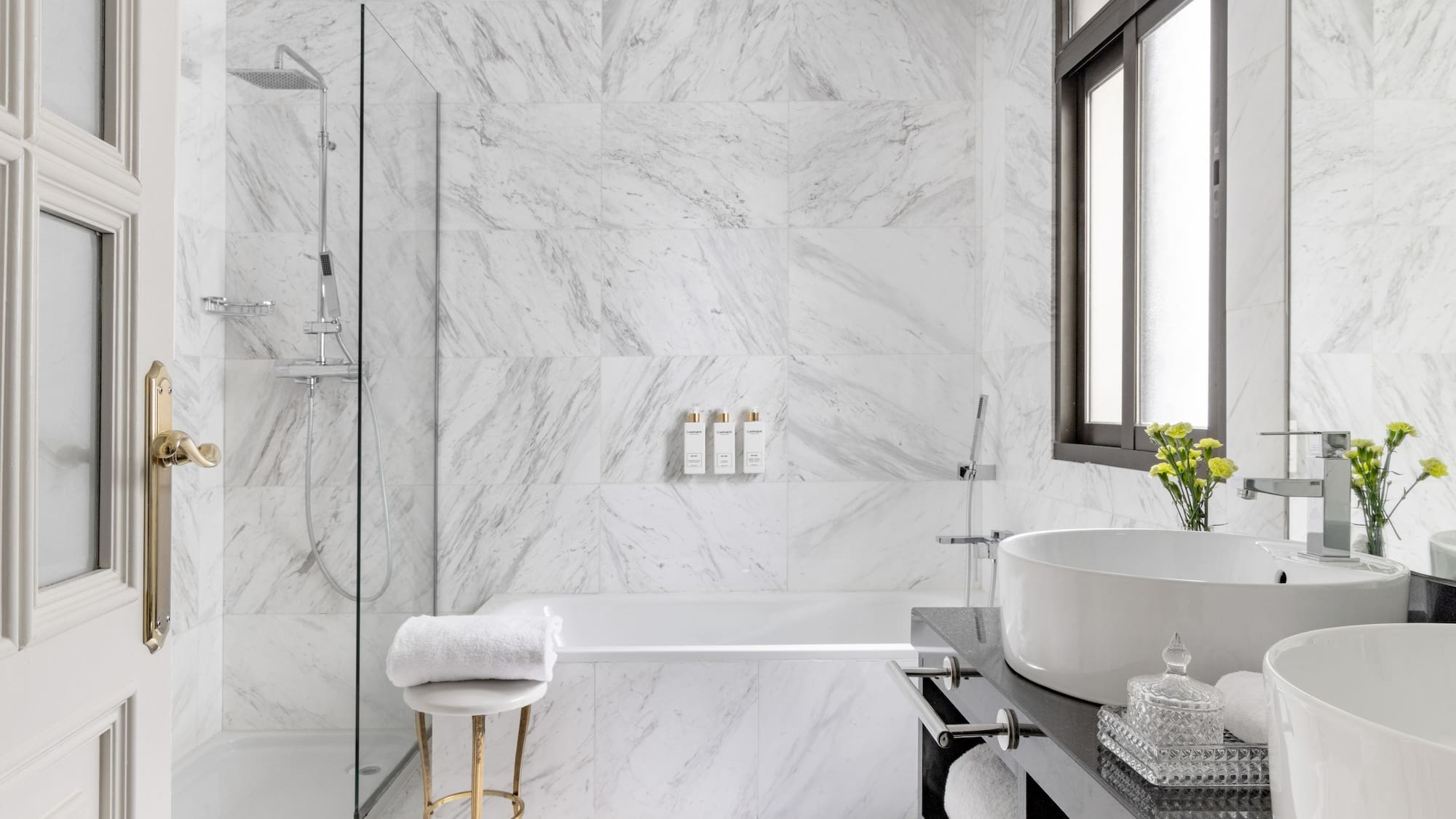 a bathroom with marble walls and a sink