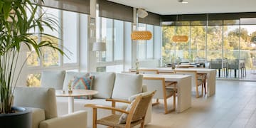 a room with white furniture and tables