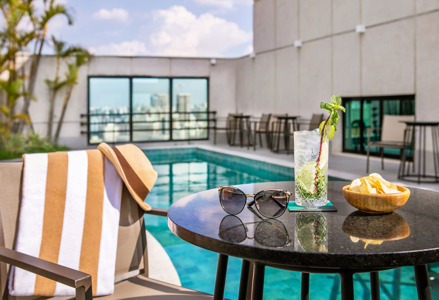 a table with sunglasses and a drink on it