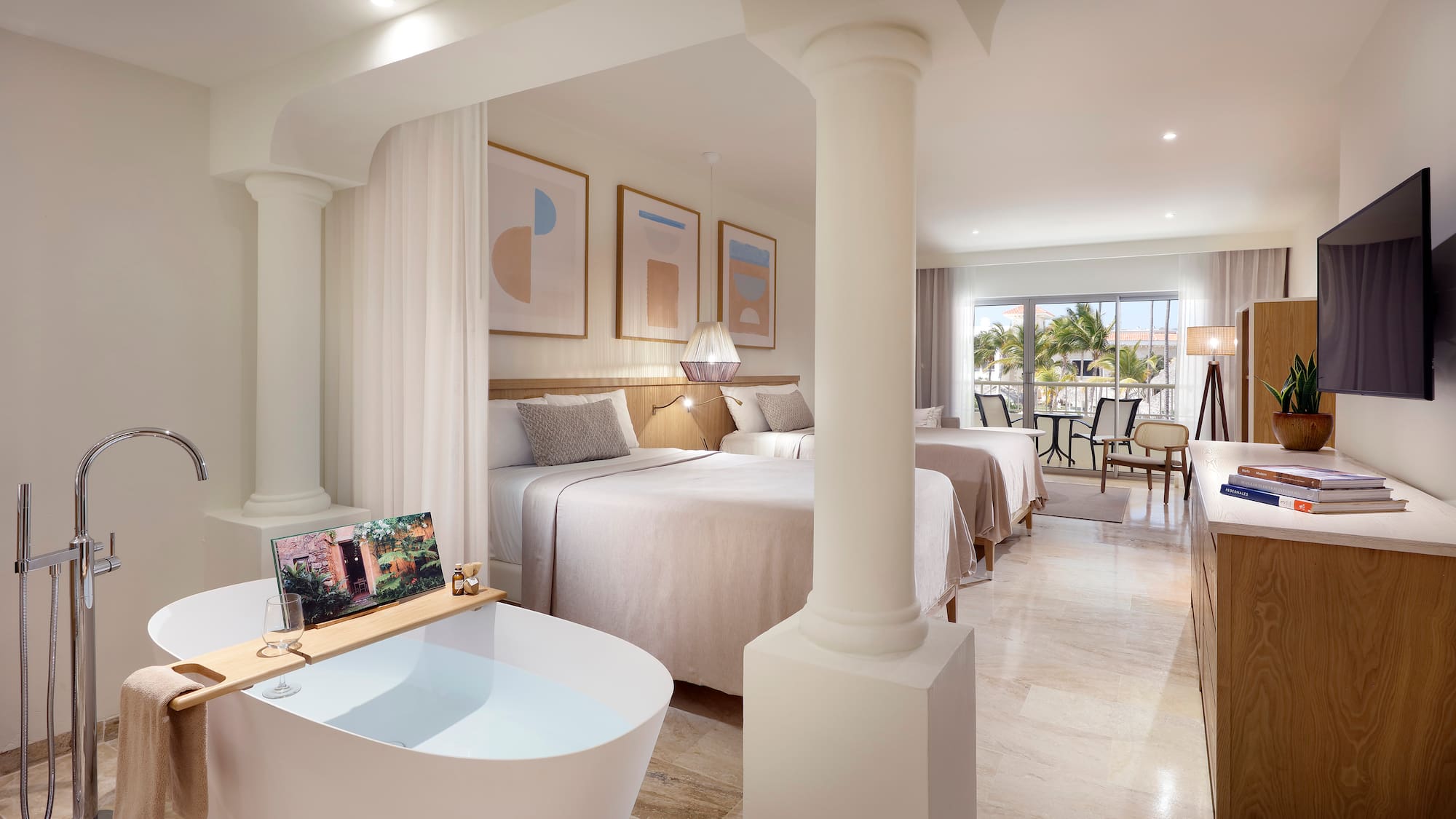 a room with two beds and a bathtub