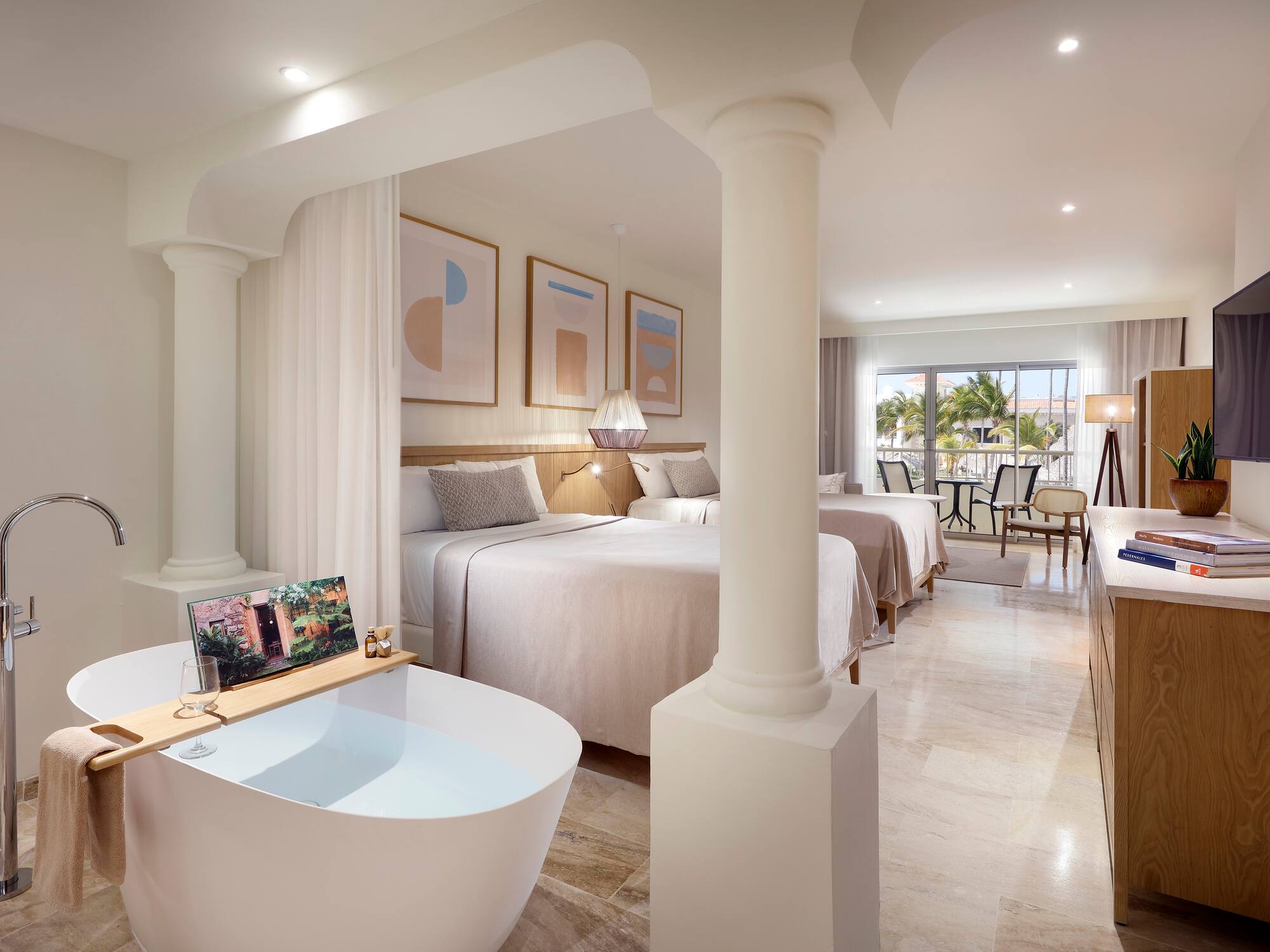 a room with two beds and a bathtub