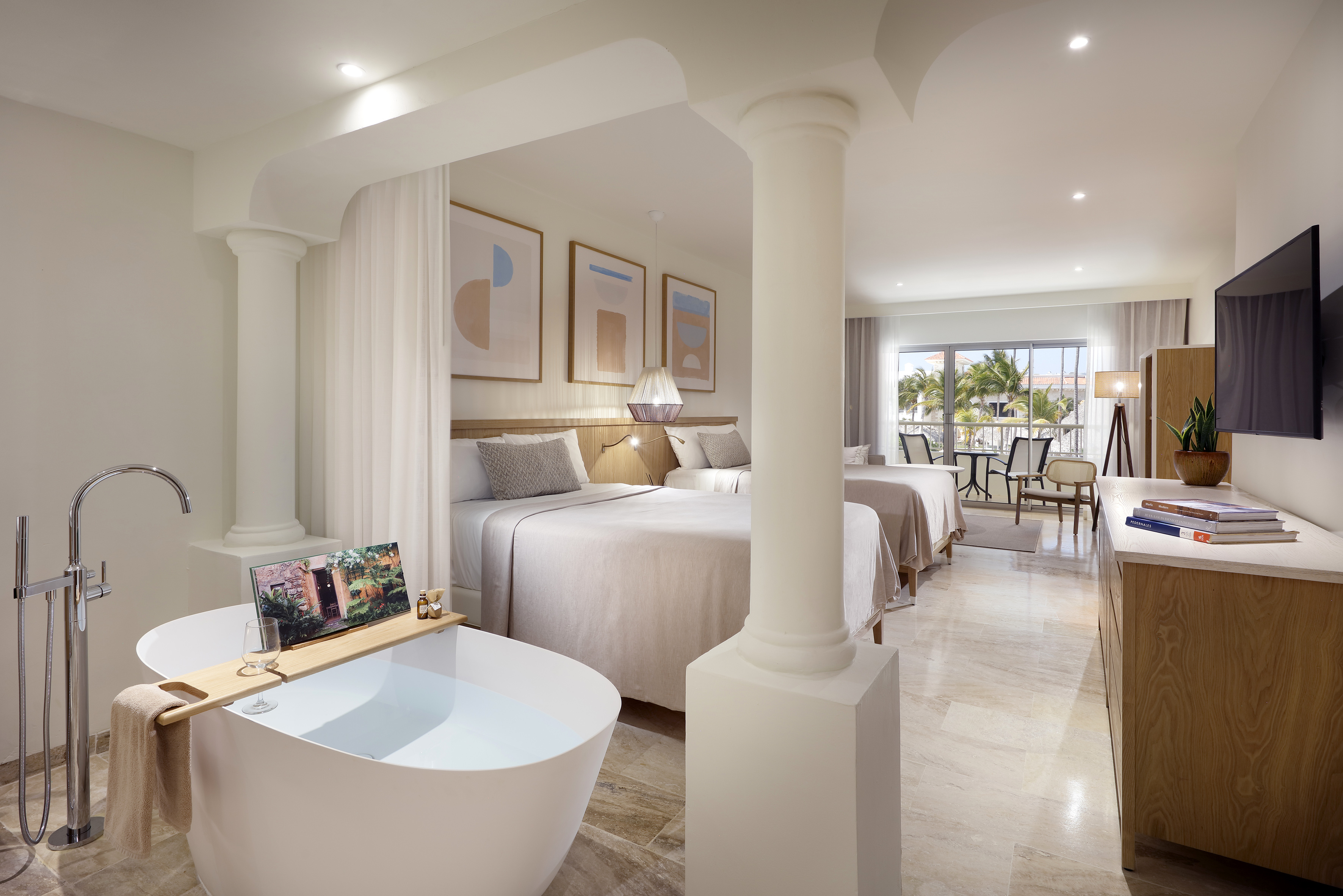 a room with two beds and a bathtub