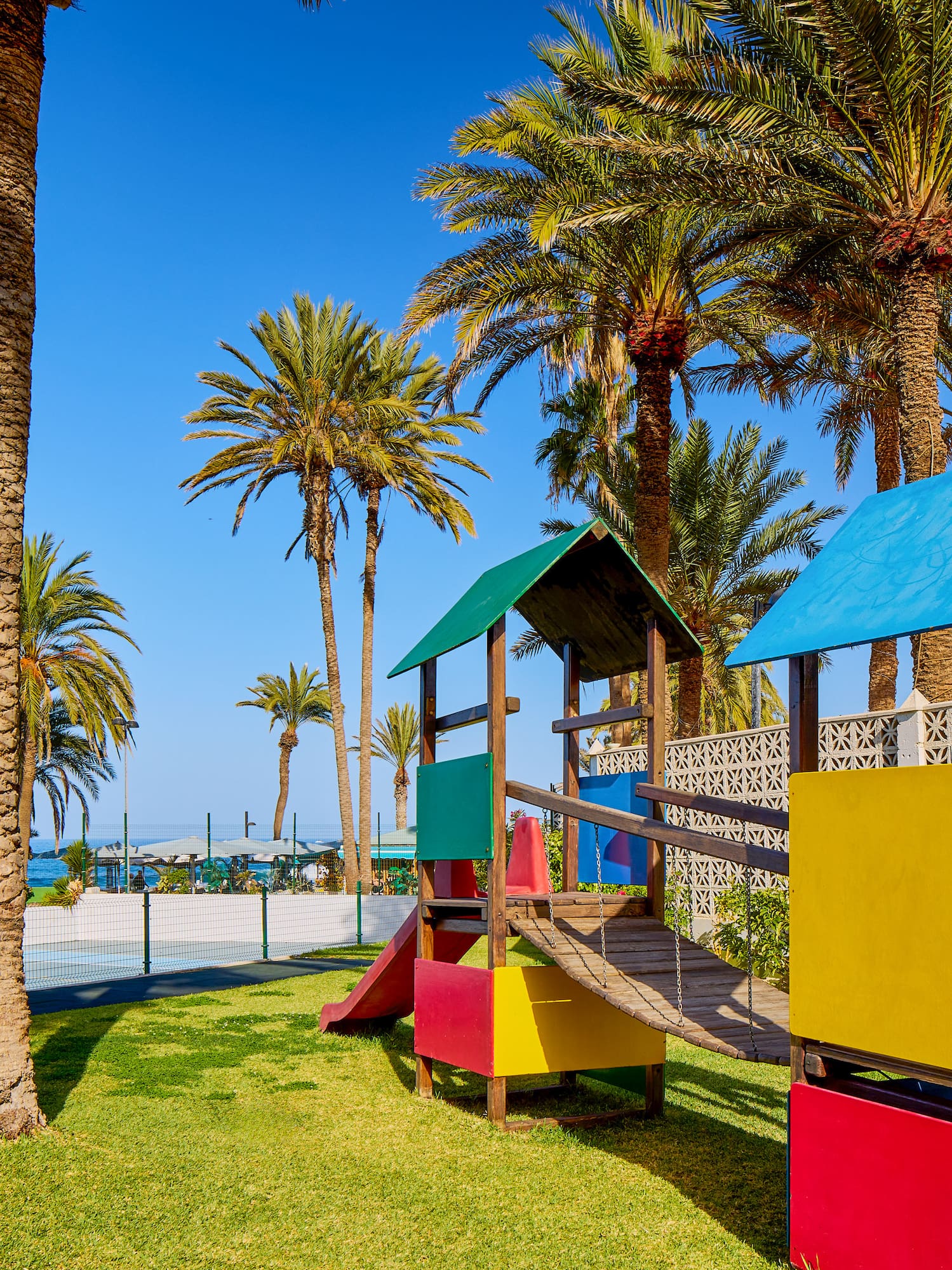 a playground with a slide and a slide in a park