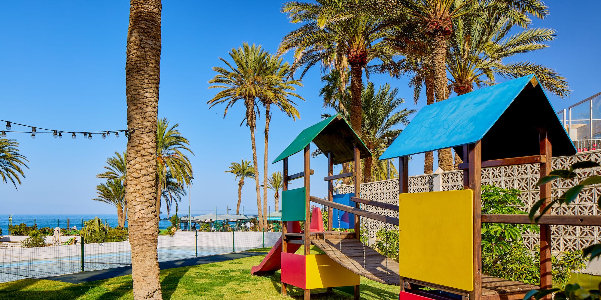 a playground with a slide and a slide in a park