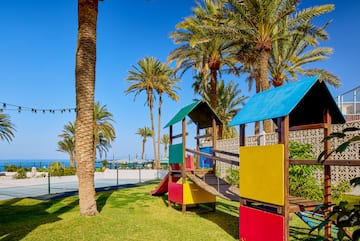 a playground with a slide and a slide in a park