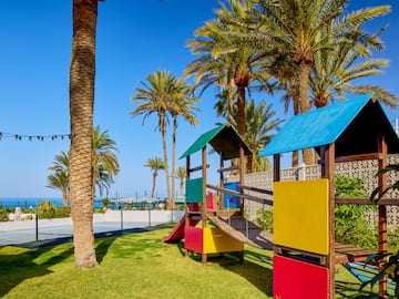 a playground with a slide and a slide in a park