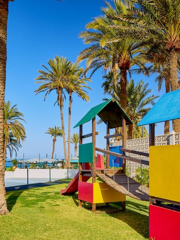 a playground with a slide and a slide in a park