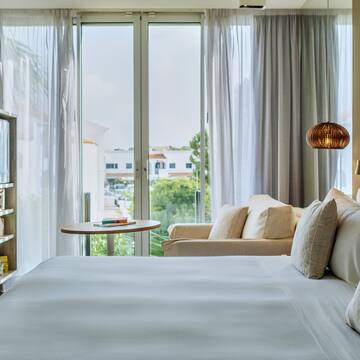 a bed with a bookcase and a lamp