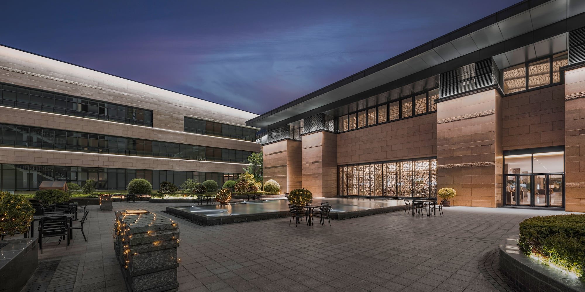 a building with a pool and chairs
