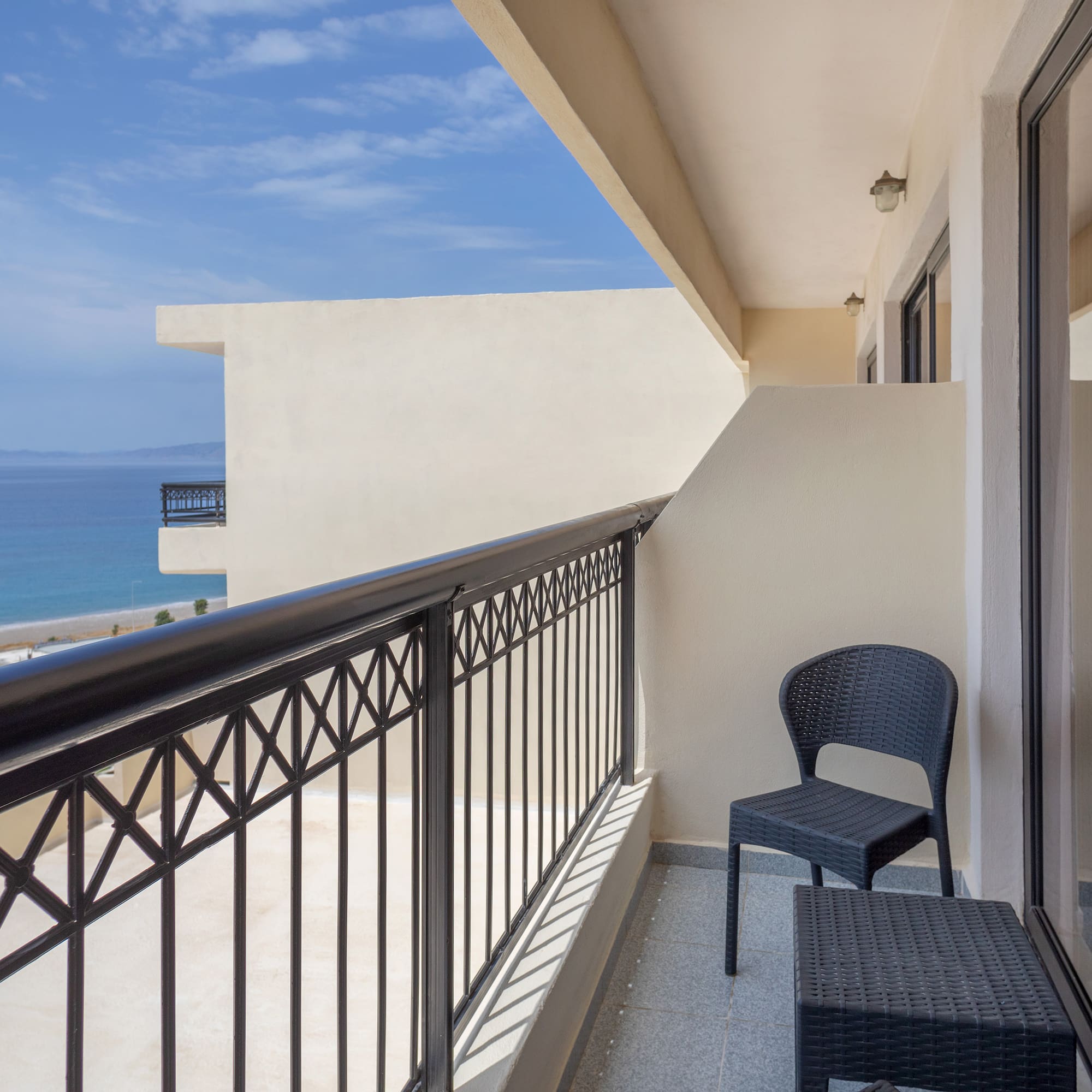a balcony with a chair and table