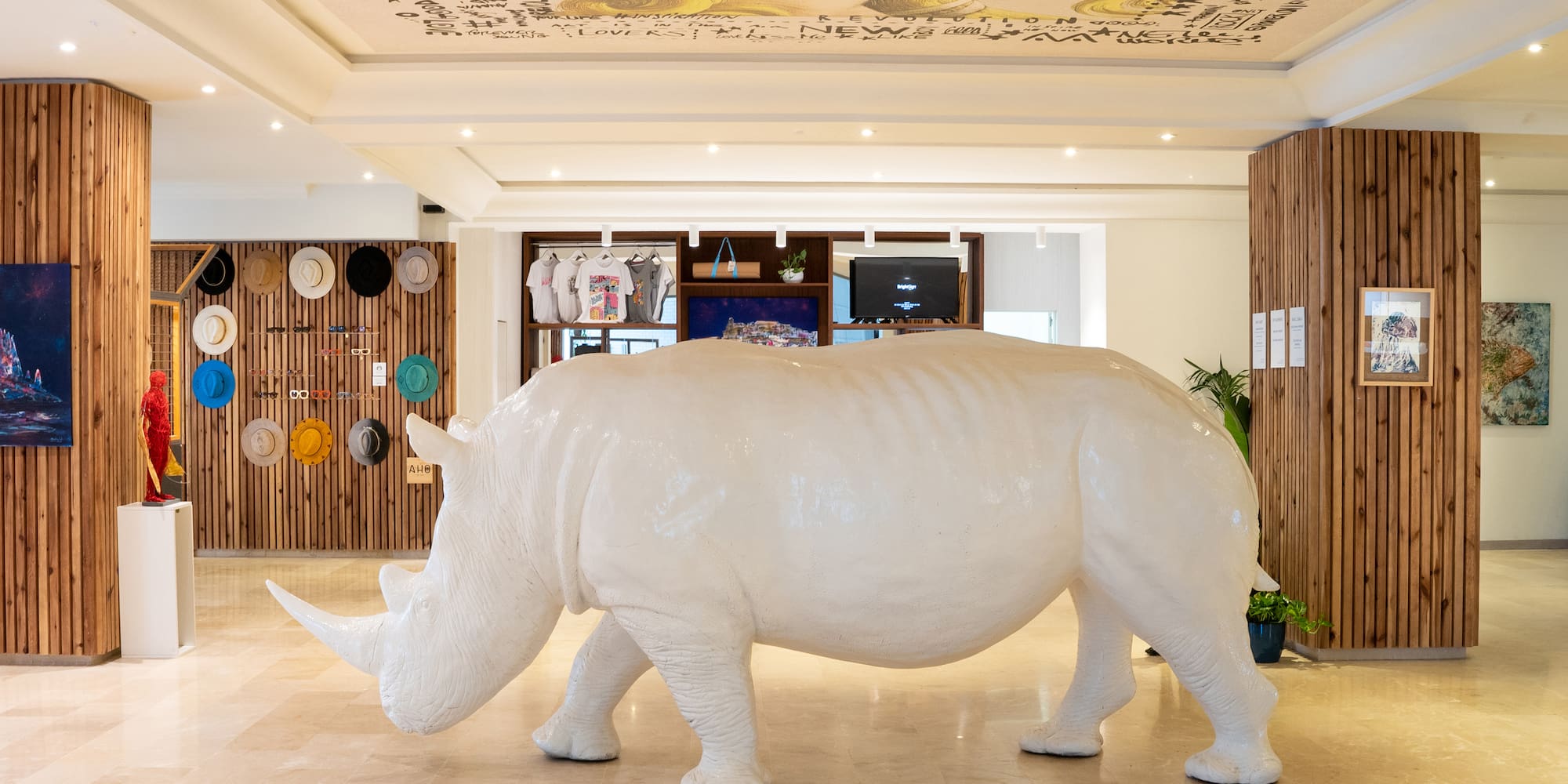 a white rhino statue in a room