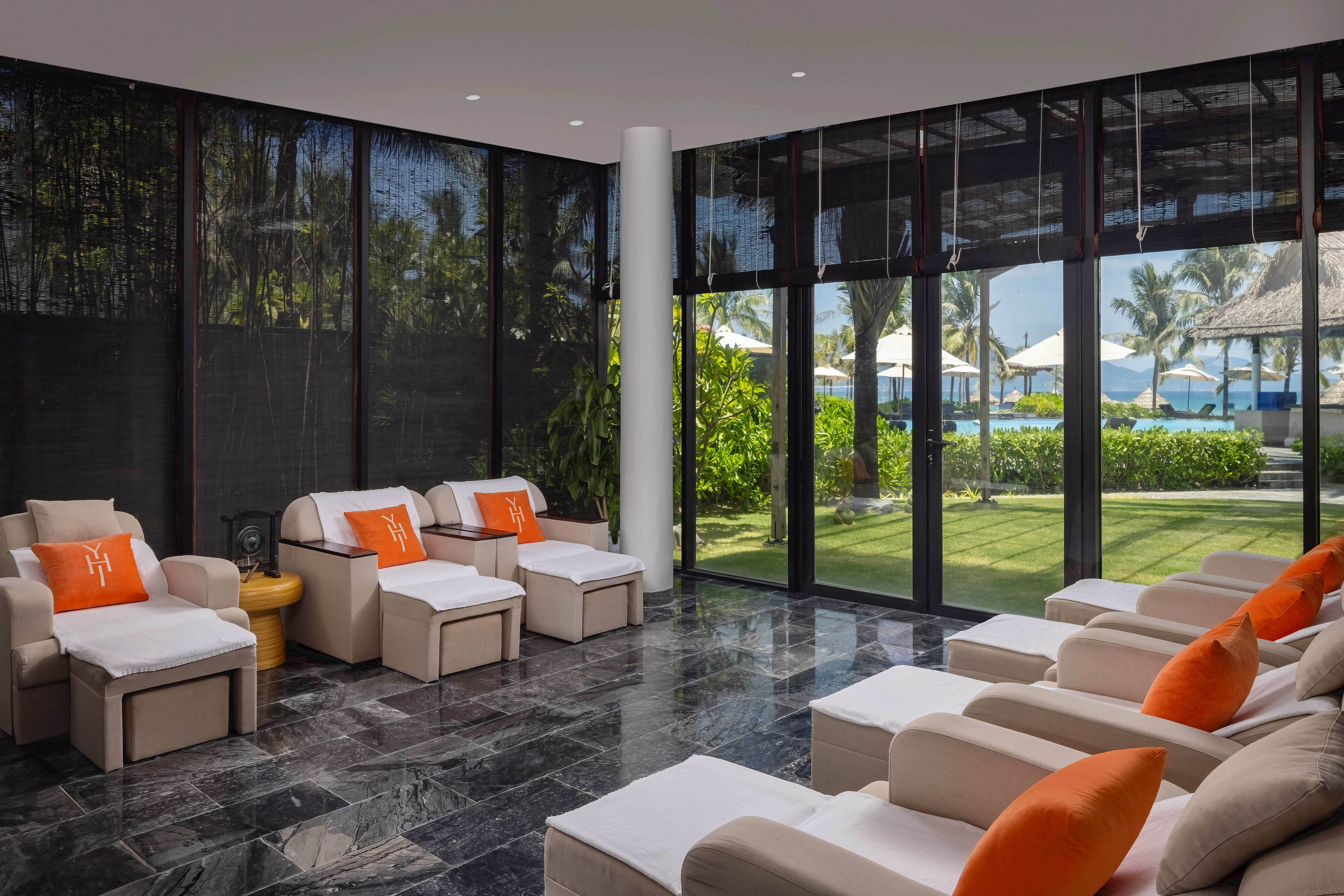 a room with white chairs and a black tile floor