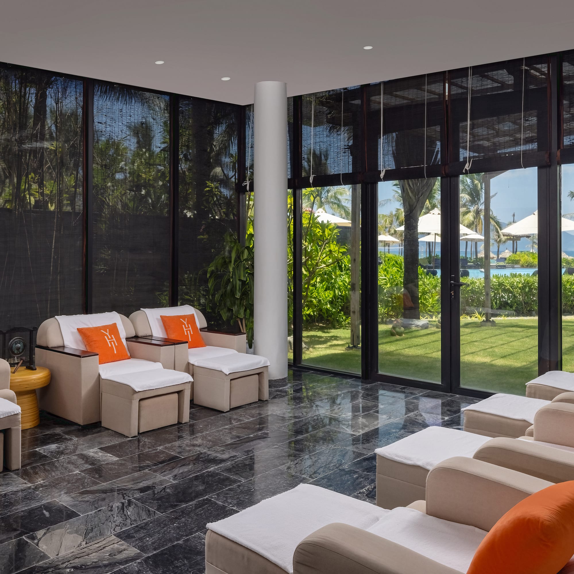 a room with white chairs and a black tile floor