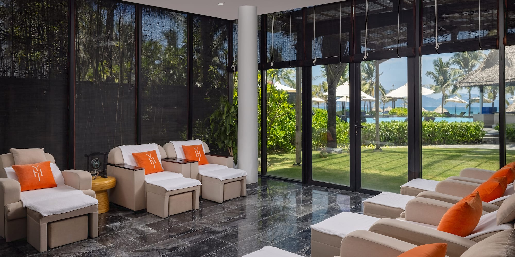 a room with white chairs and a black tile floor