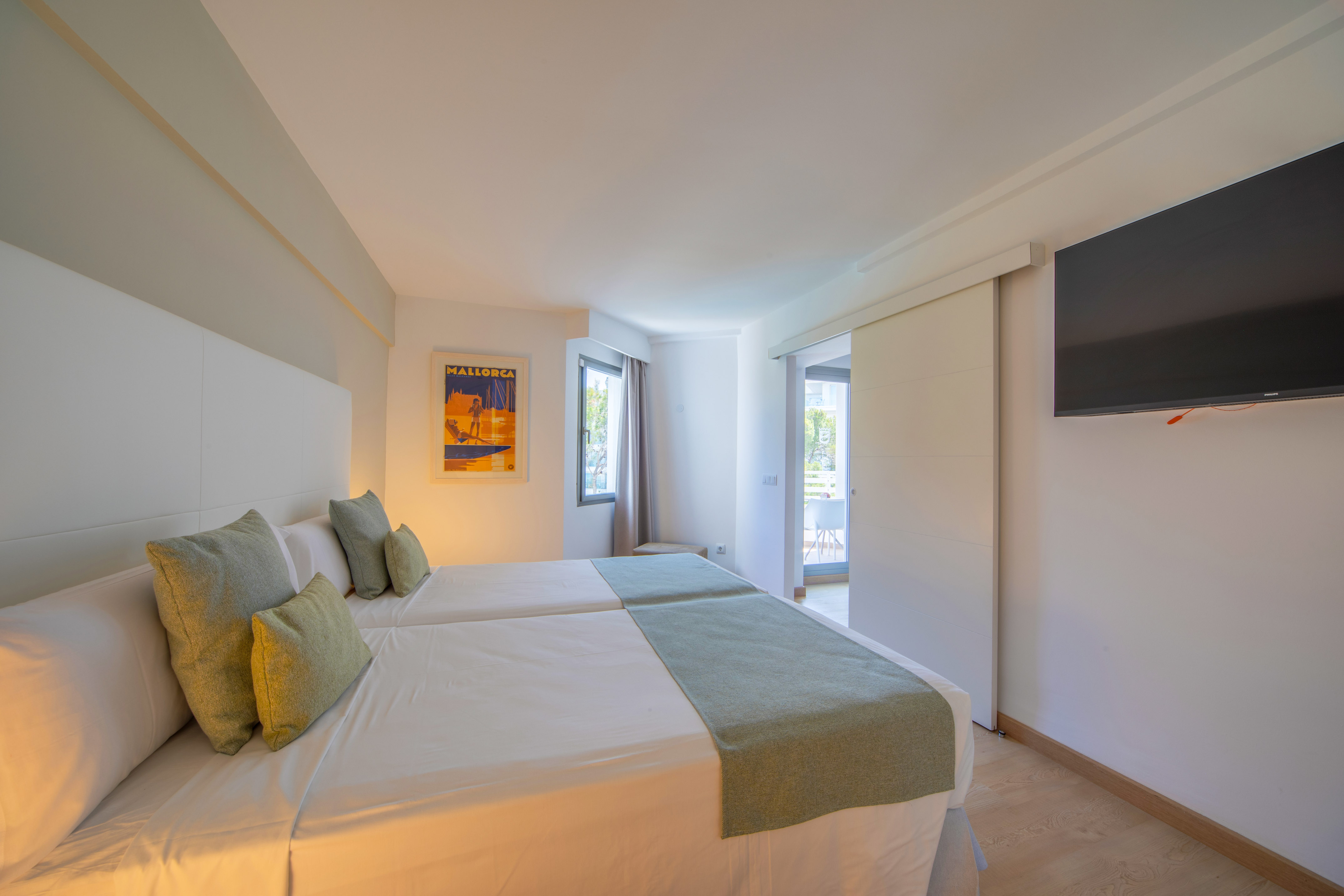 a room with two beds and a television