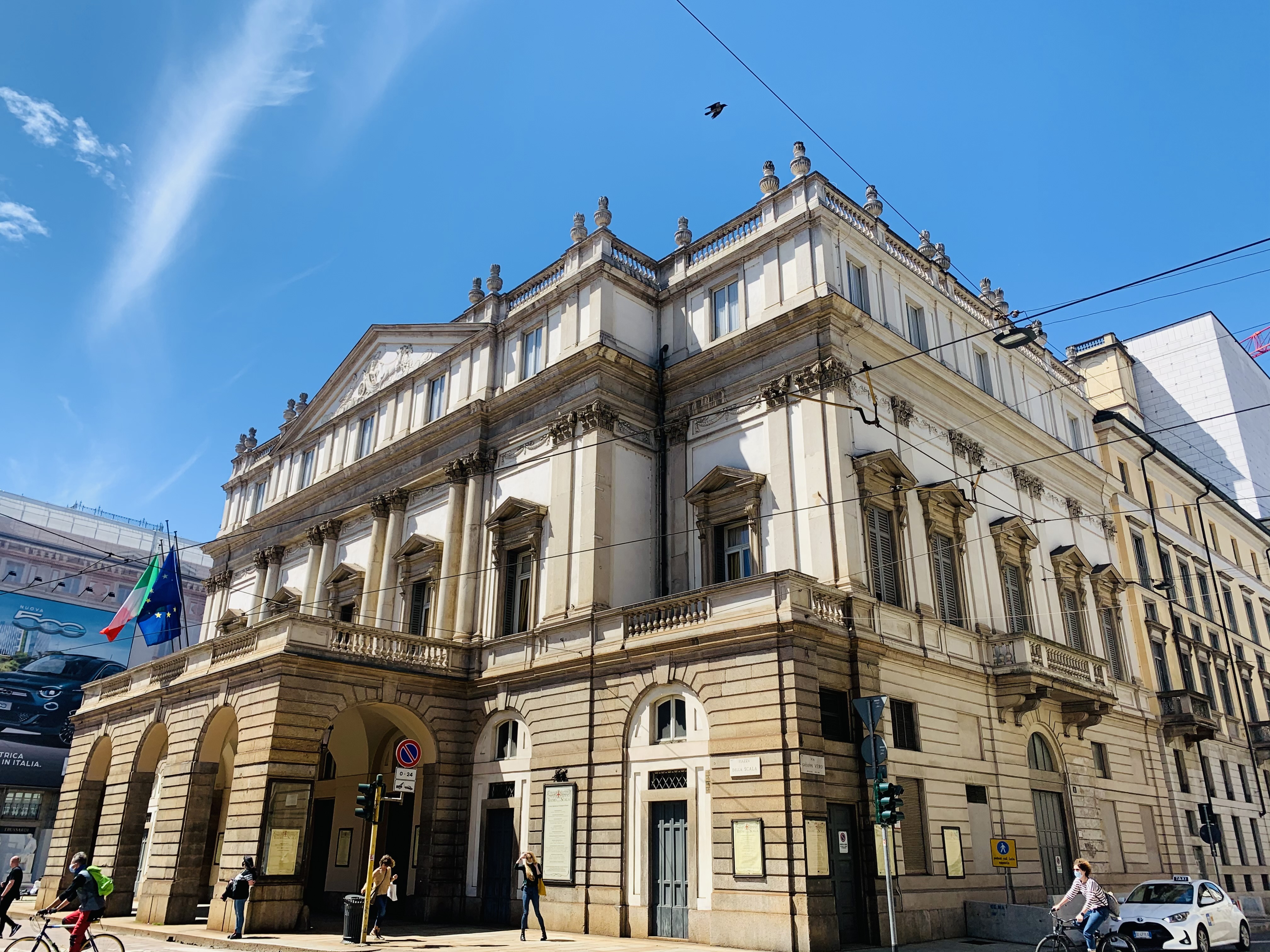 a building with people walking on the street