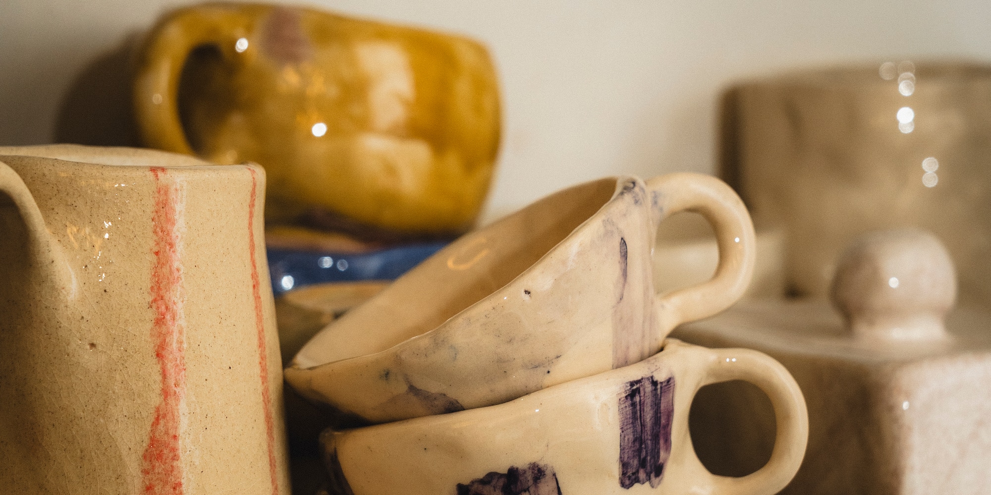a group of ceramic cups and mugs