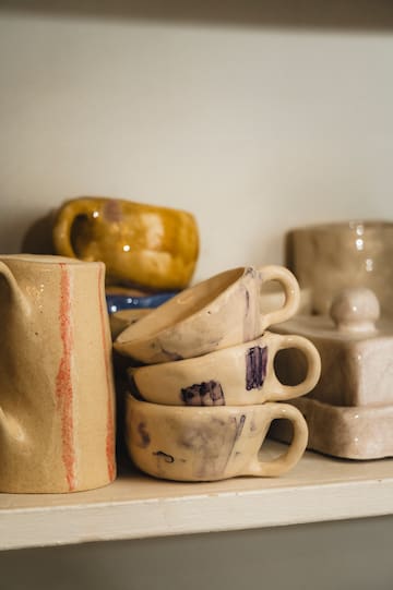 a group of ceramic cups and mugs