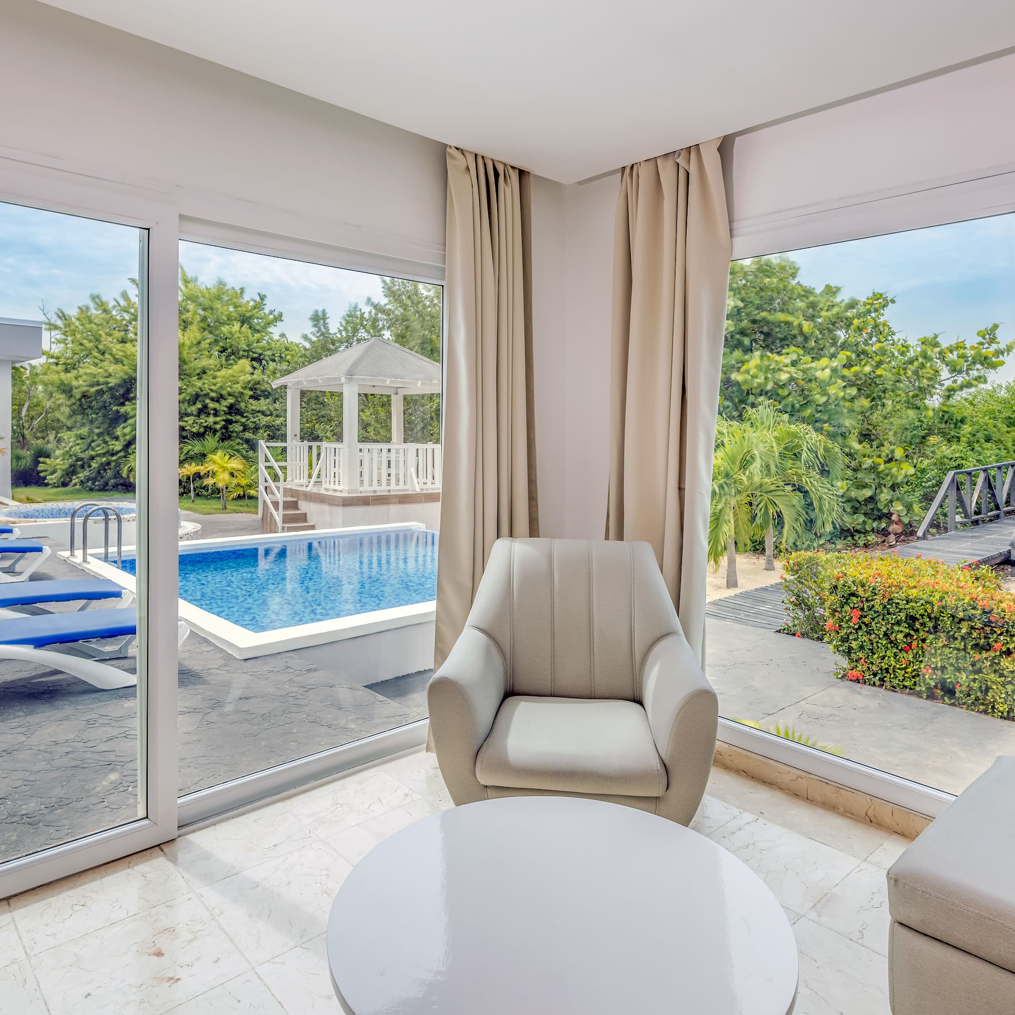 a room with a pool and chairs