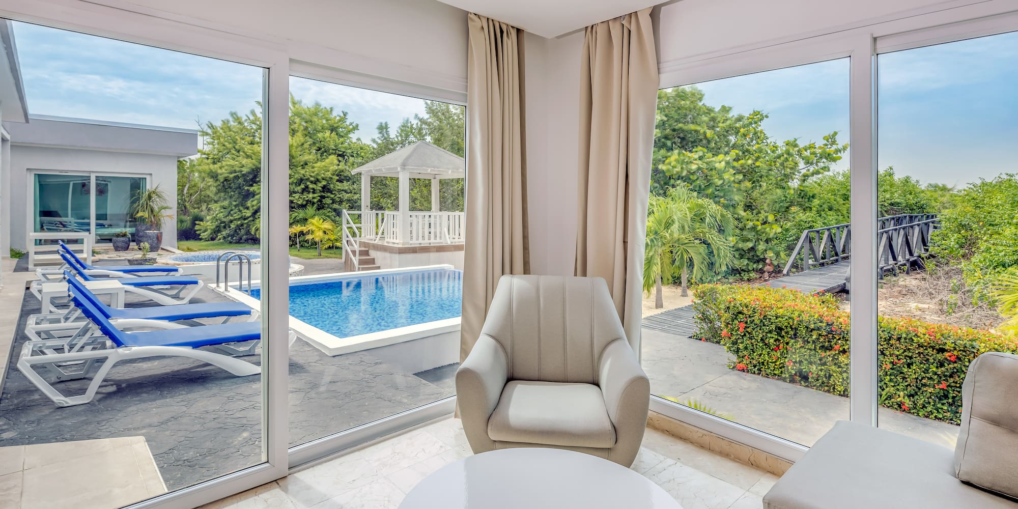 a room with a pool and chairs