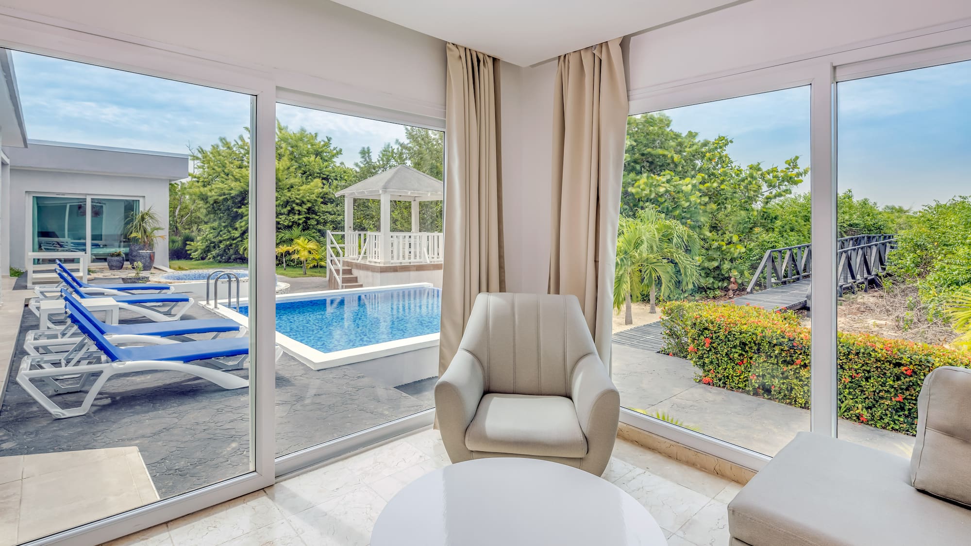 a room with a pool and chairs