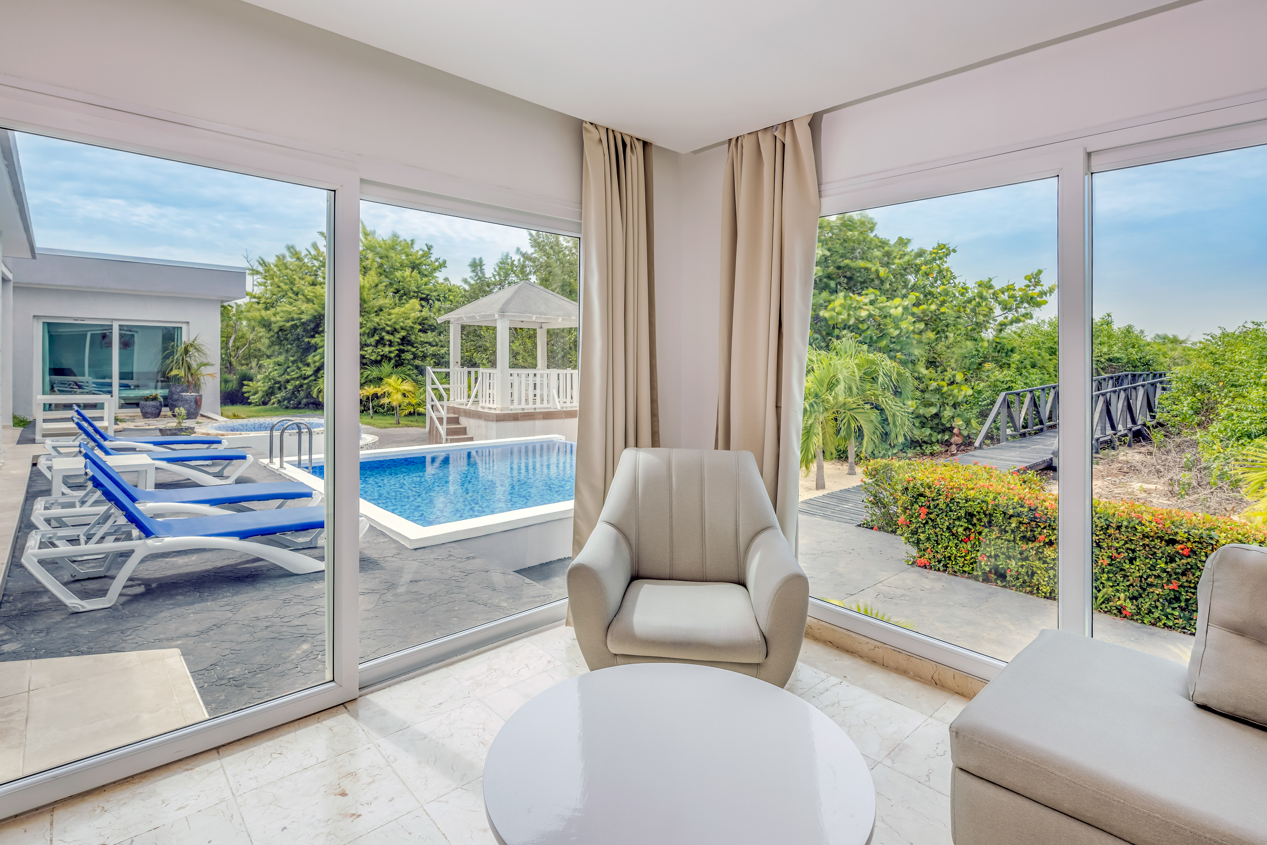a room with a pool and chairs