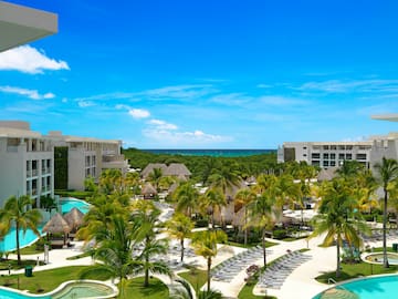 a pool and palm trees in a resort