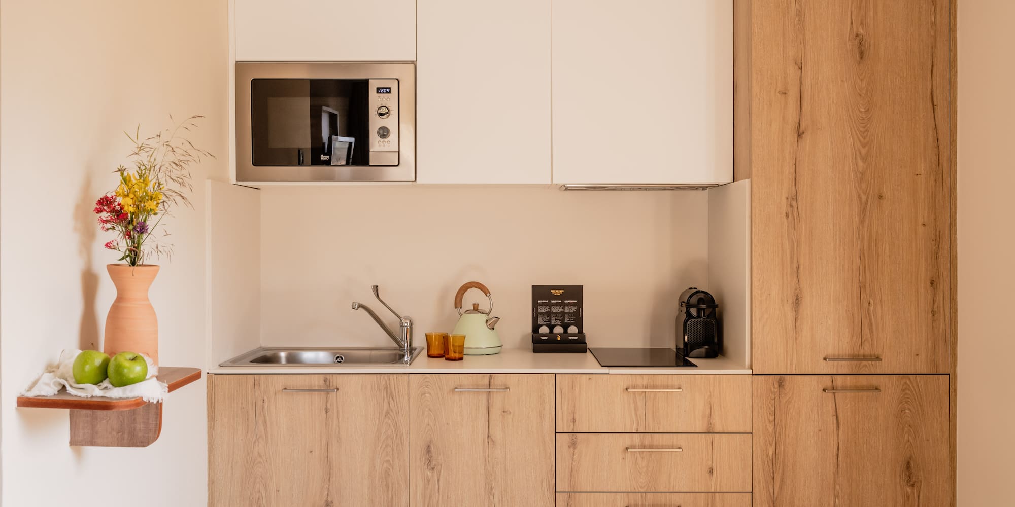 a kitchen with white cabinets and a microwave