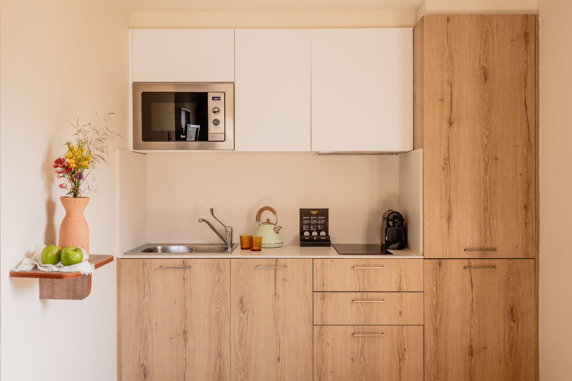 a kitchen with white cabinets and a microwave