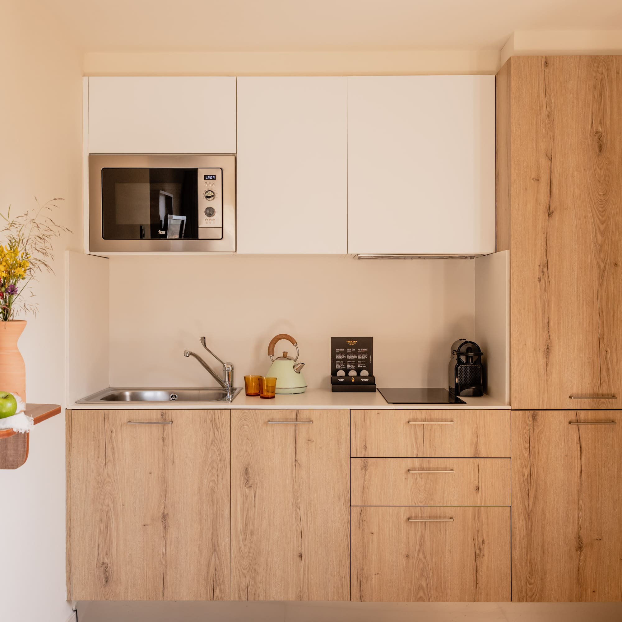 a kitchen with white cabinets and a microwave