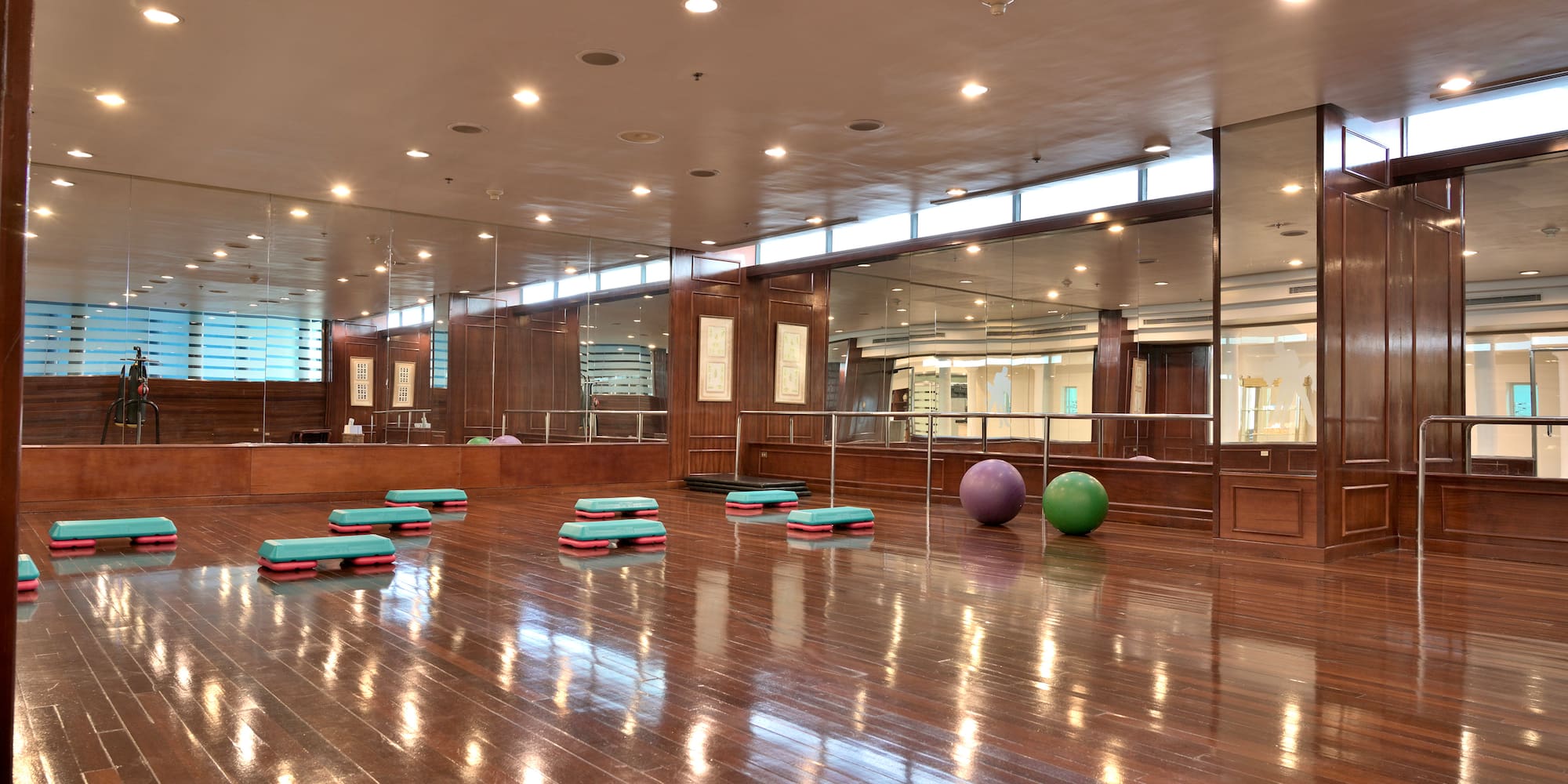 a room with a mirror wall and a mirror on the wall