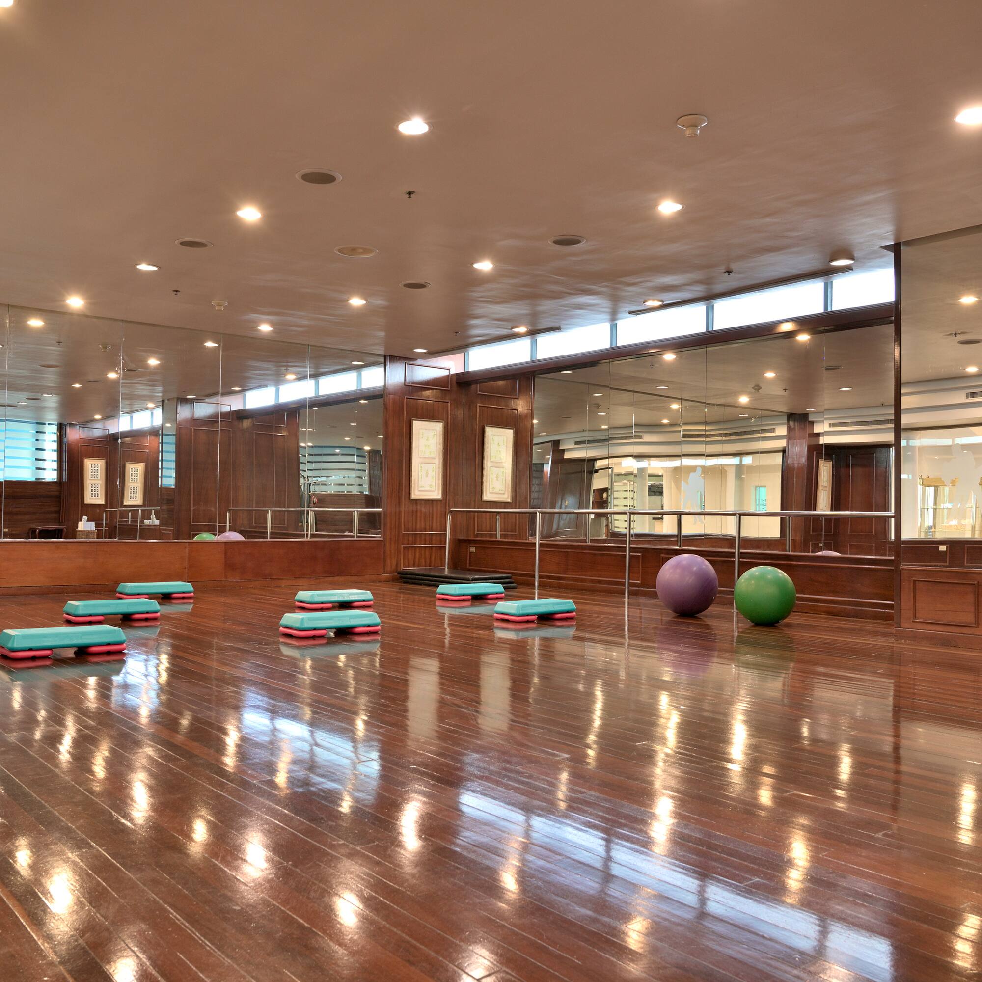 a room with a mirror wall and a mirror on the wall