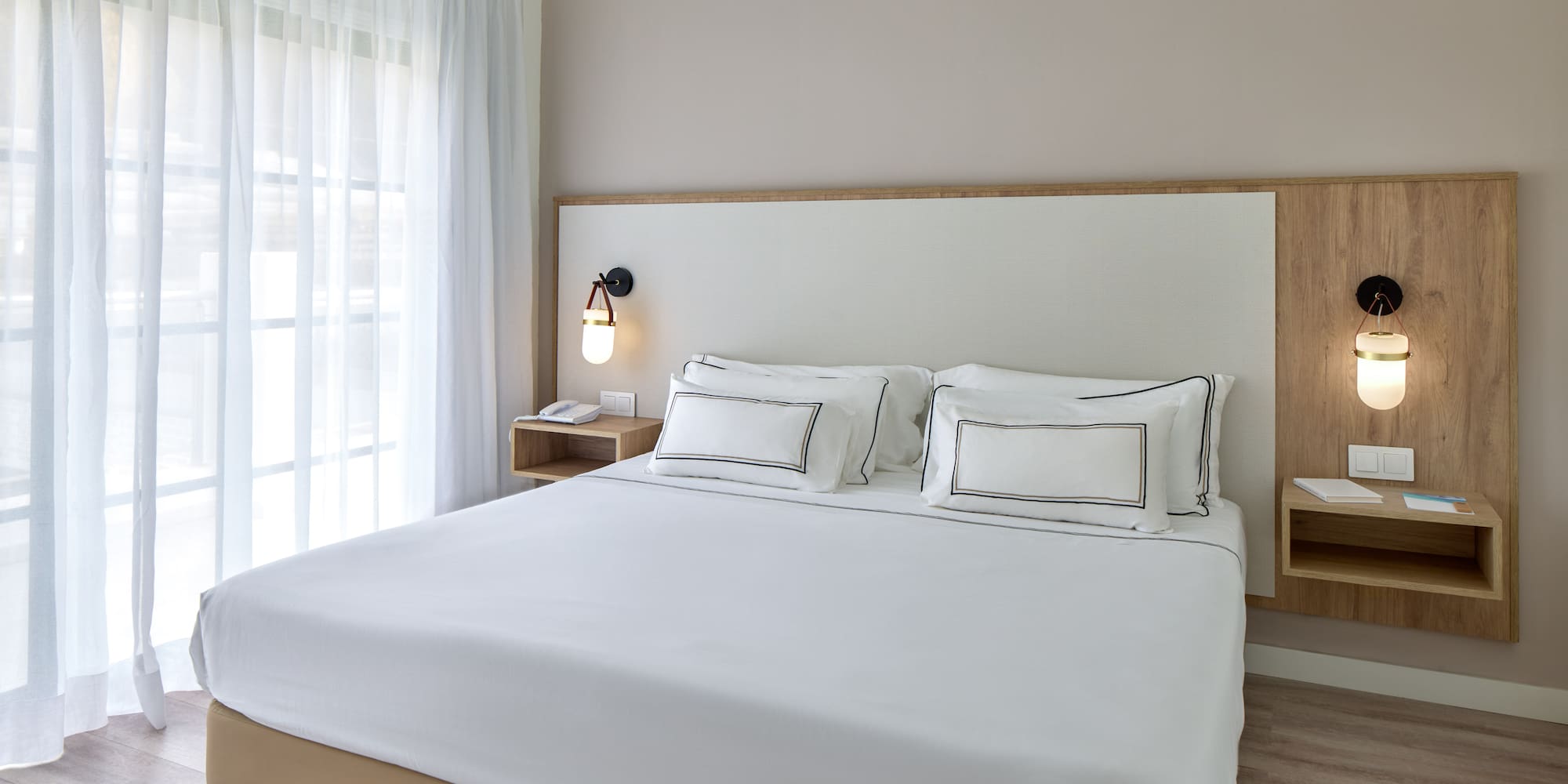 a bed with white sheets and a lamp