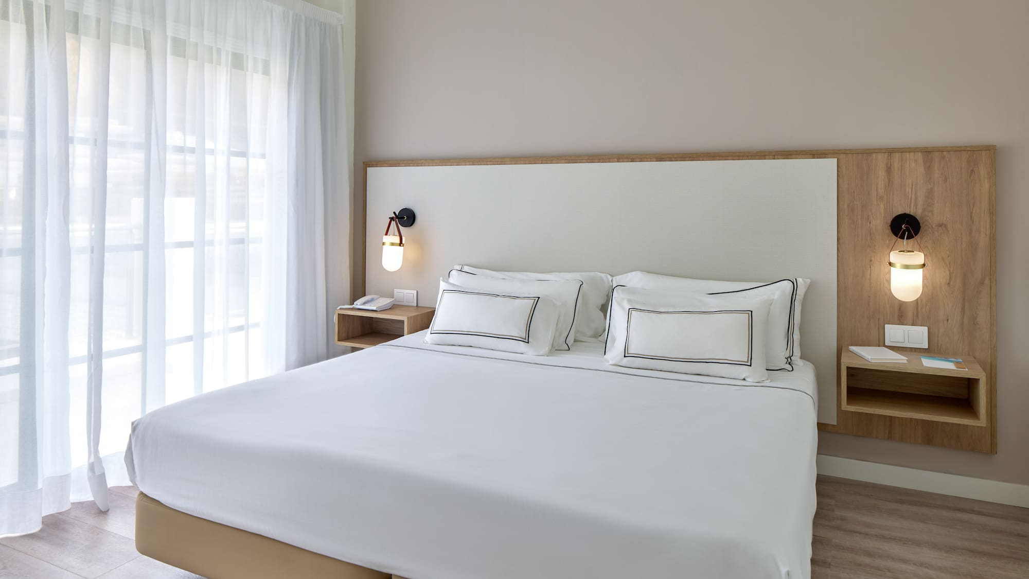 a bed with white sheets and a lamp
