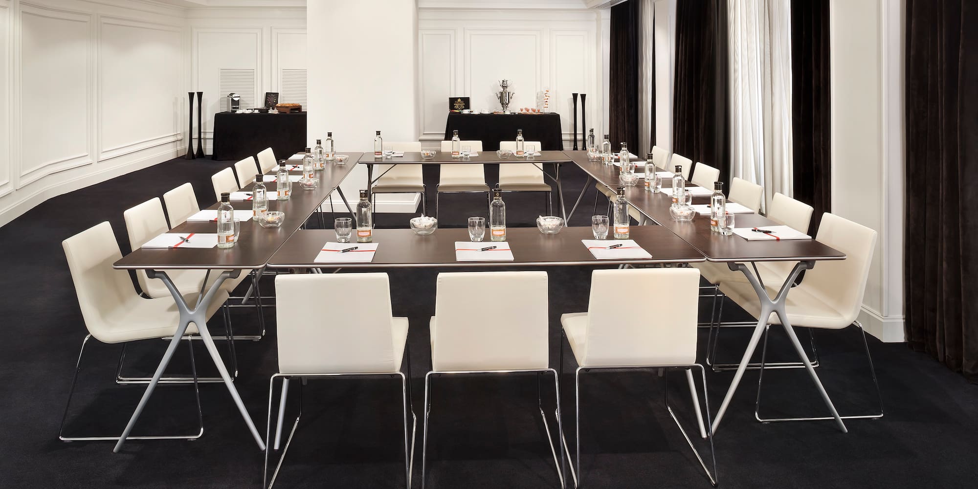 a room with a long table and chairs