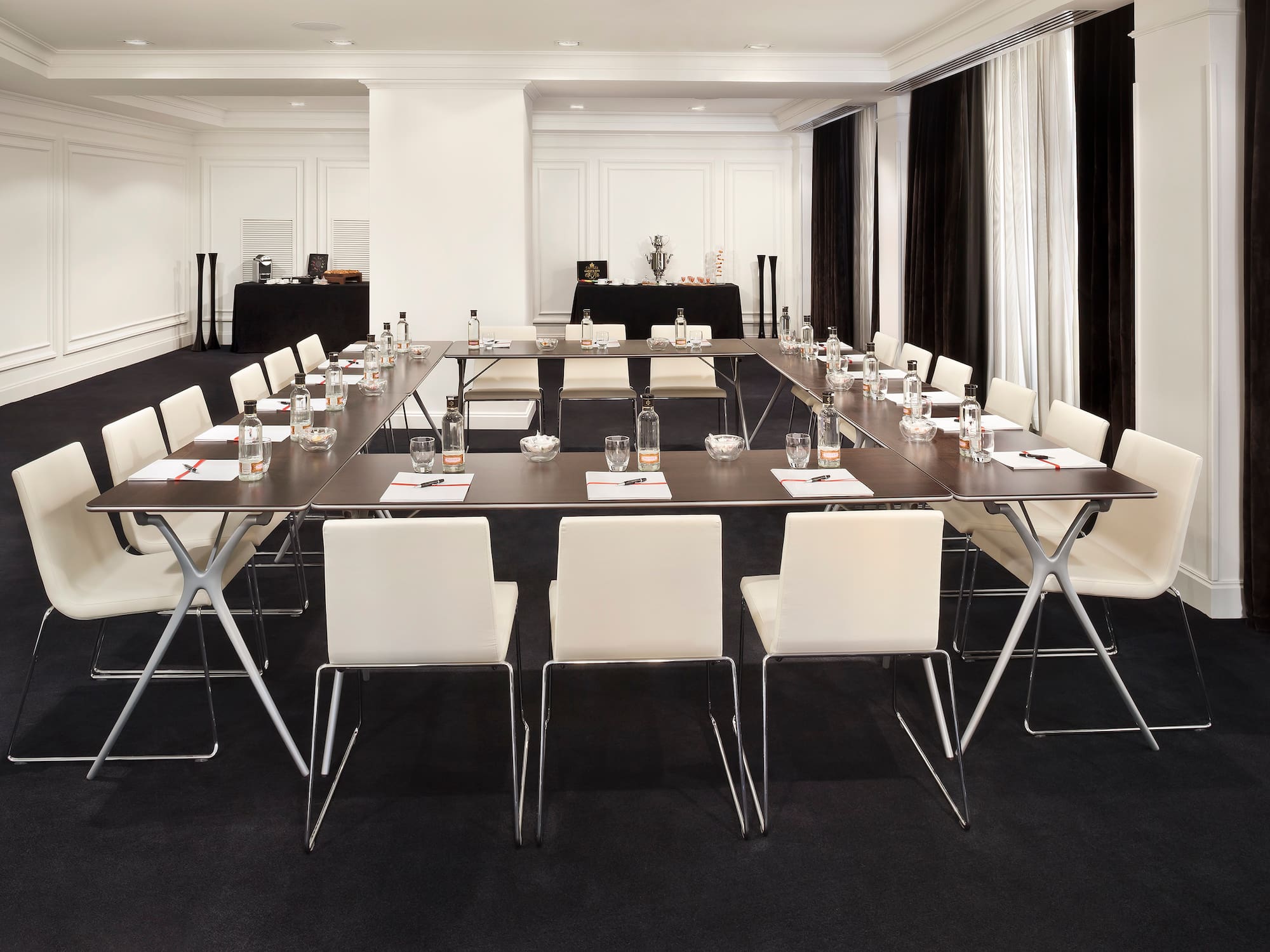 a room with a long table and chairs