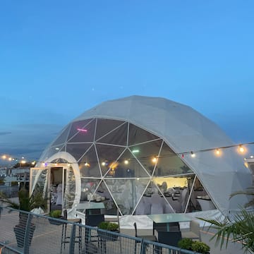 a dome tent with lights and a fence
