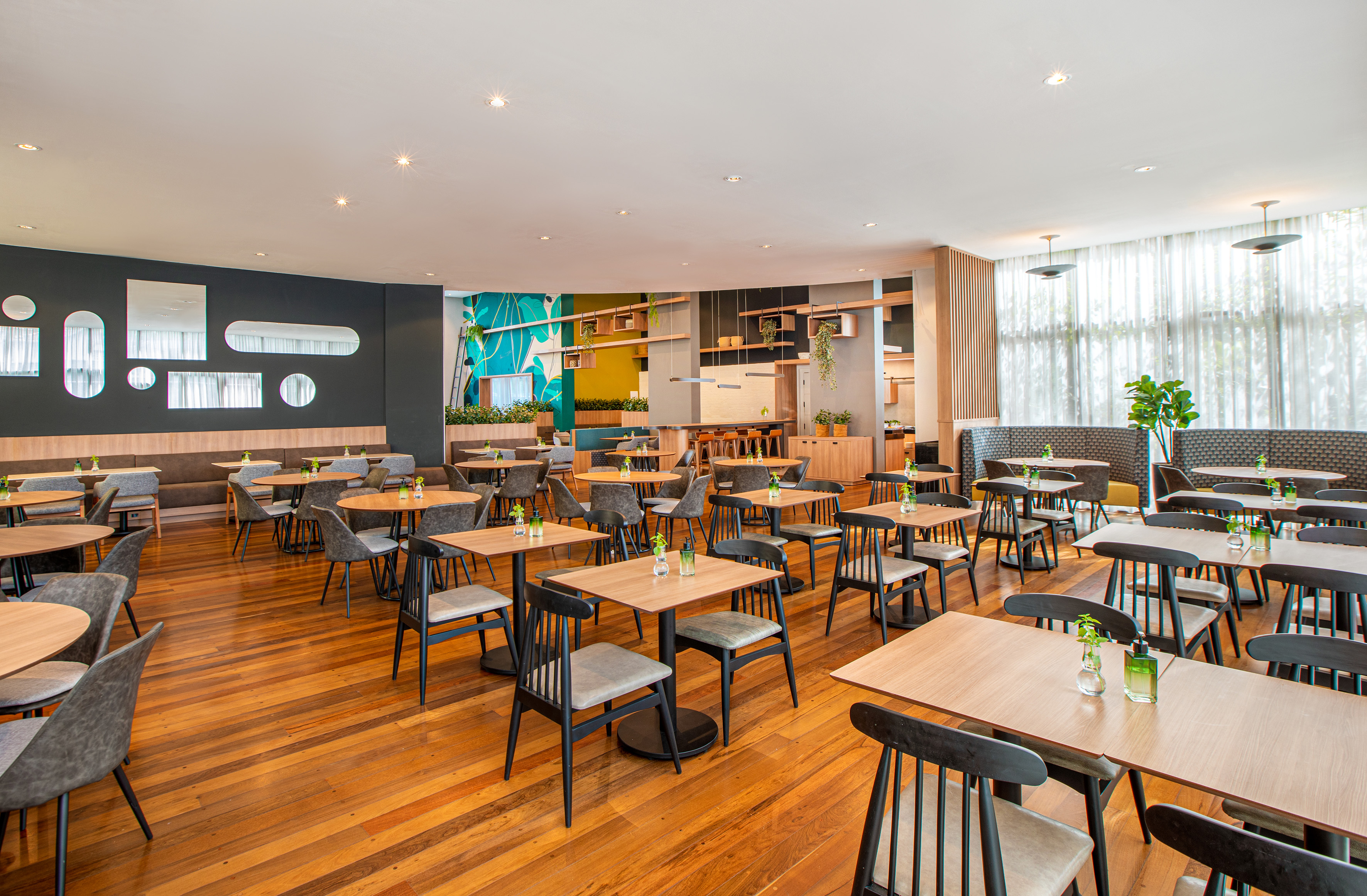 Stylish cafe dining area with wood floors and modern decor.